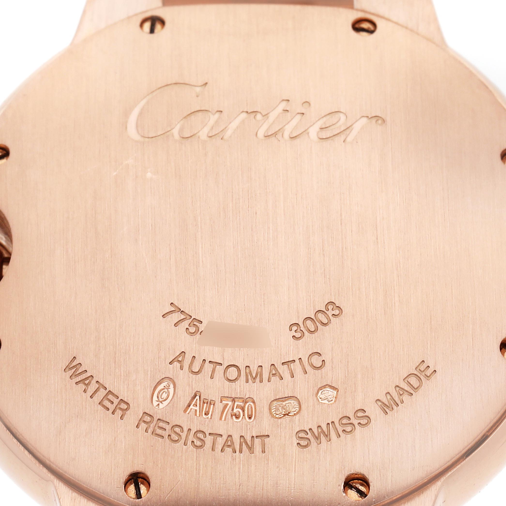 The image shows the back case of a Cartier Ballon Bleu WE9005Z3 Women
s Rose Gold Silver Dial WE9005Z3 Women
s Rose Gold Silver Dial watch, featuring engraved details and screws.