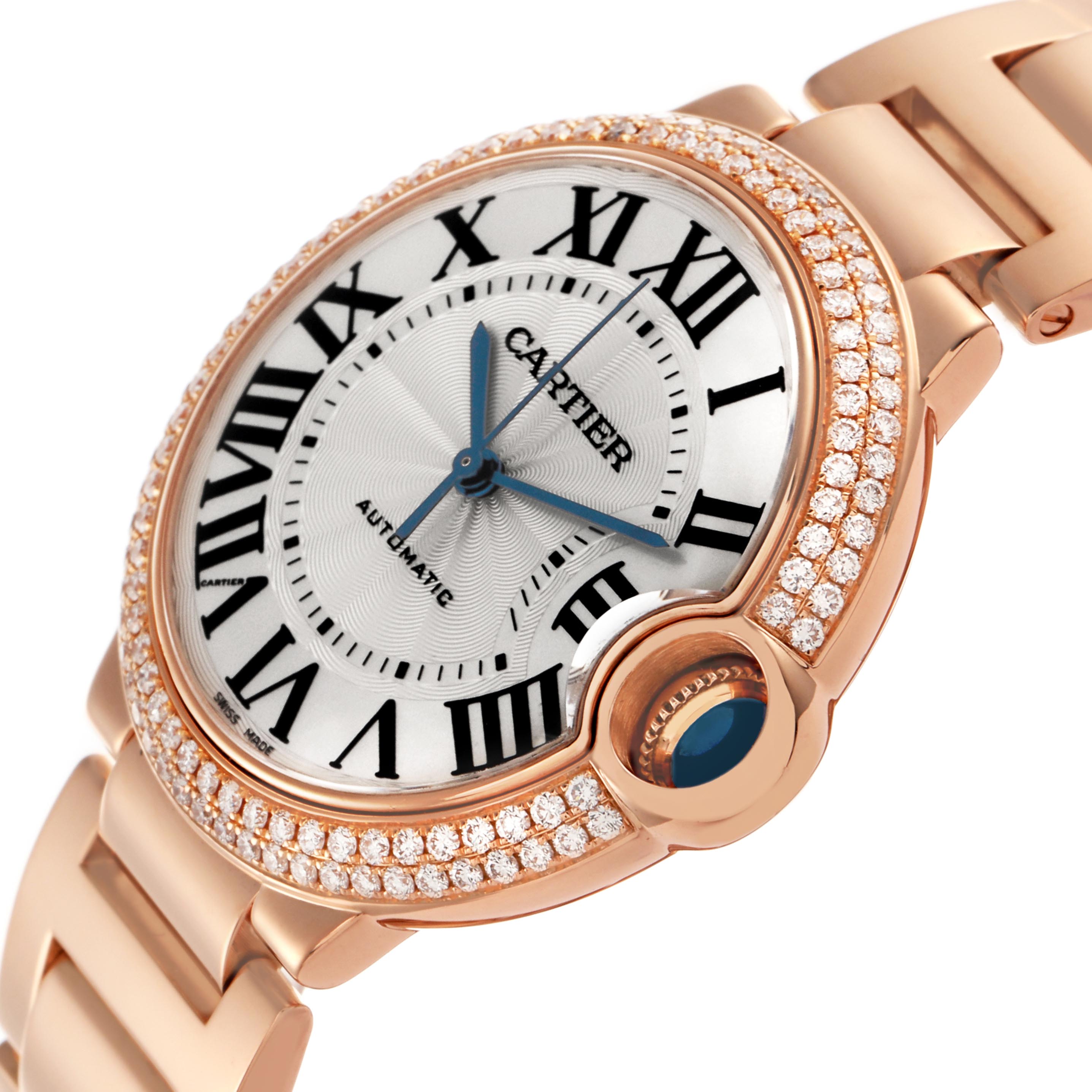 The Cartier Ballon Bleu WE9005Z3 Women
s Rose Gold Silver Dial WE9005Z3 Women
s Rose Gold Silver Dial watch is shown at an angle highlighting its face, diamond-studded bezel, and the distinctive blue cabochon crown.