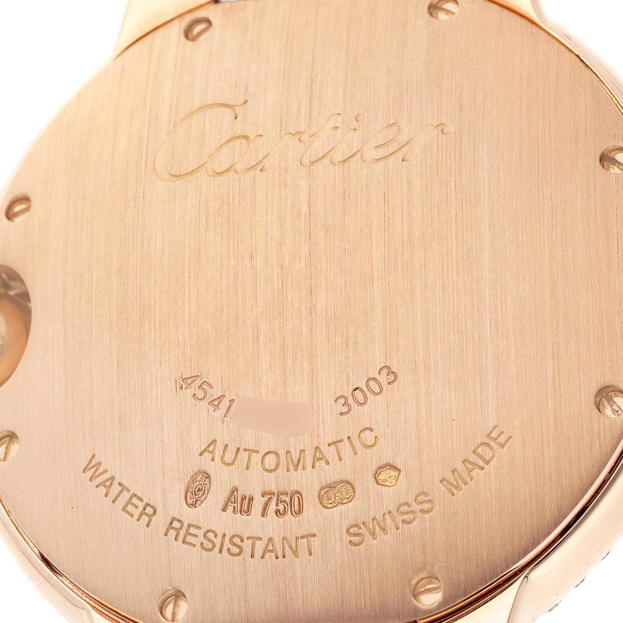 The image shows the back of a Ballon Bleu de Cartier watch, featuring engravings and technical details.