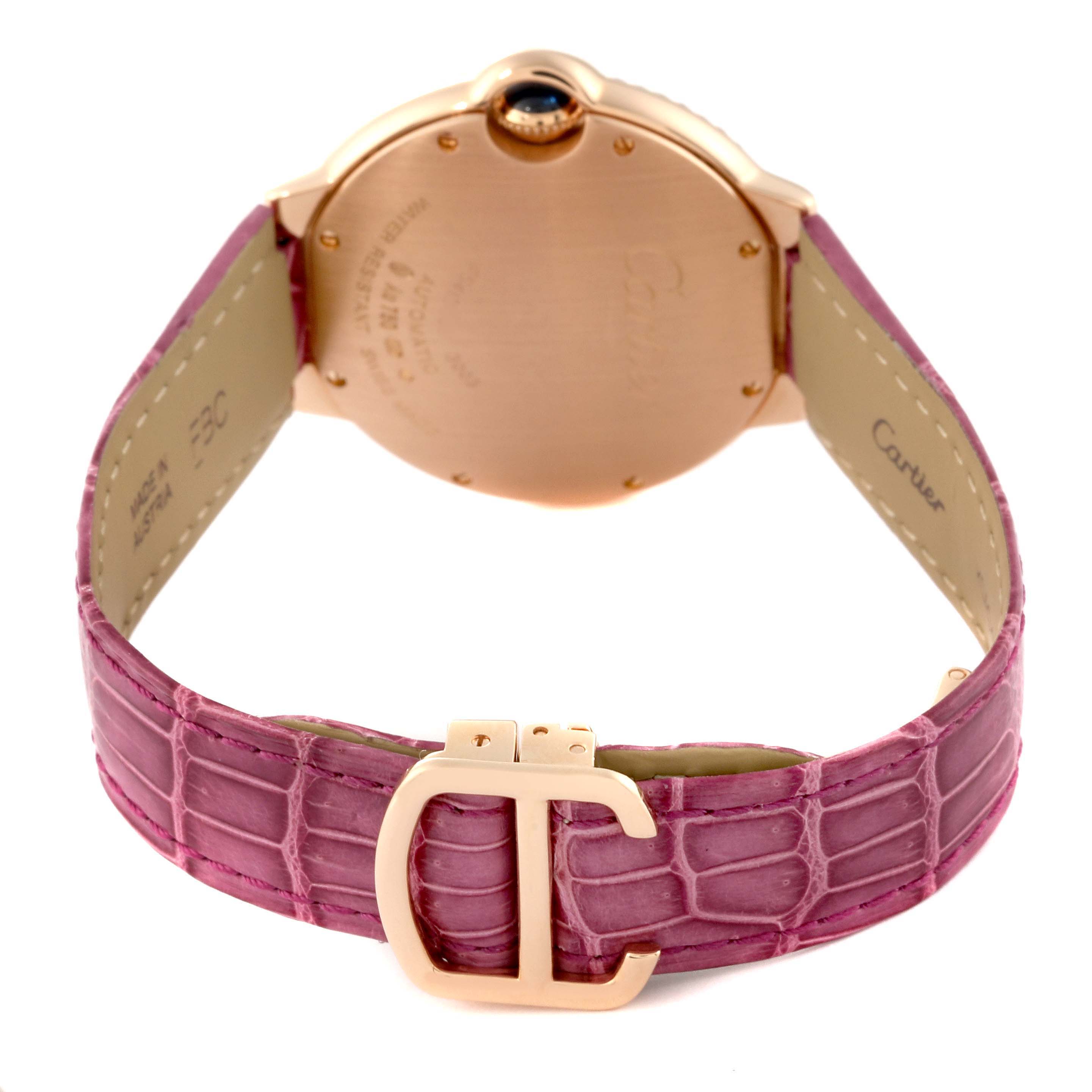 The image shows the back view of a Cartier Ballon Bleu WE900551 Women's Rose Gold Silver Dial WE900551 Women's Rose Gold Silver Dial watch, focusing on the case back, crown, and pink alligator leather strap with a clasp.