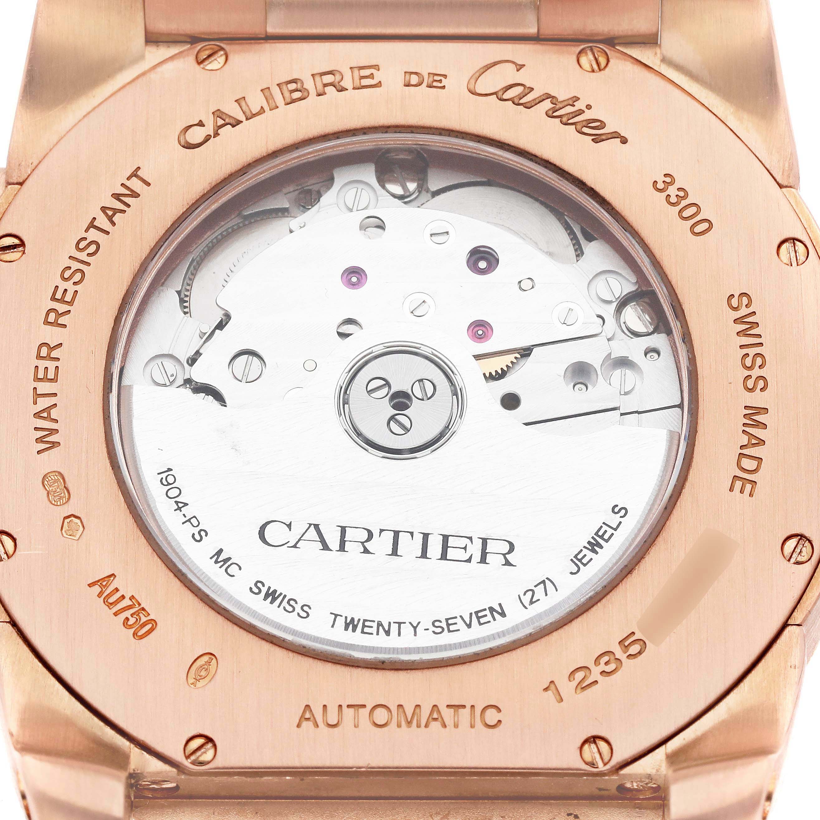 The image shows the back casing of a Calibre de Cartier watch by Cartier, highlighting the automatic movement and internal mechanics.