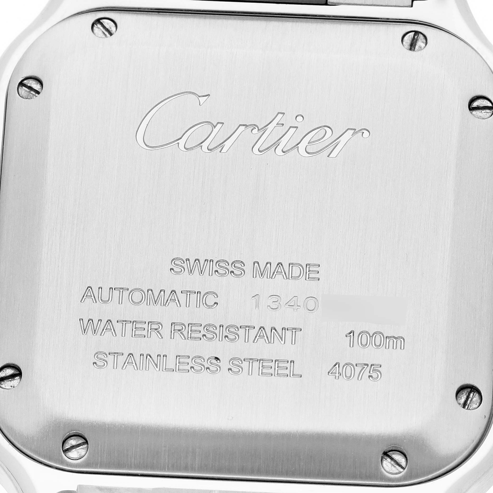The image shows the back case of a Santos model Cartier watch, showcasing its engravings and metal finish.