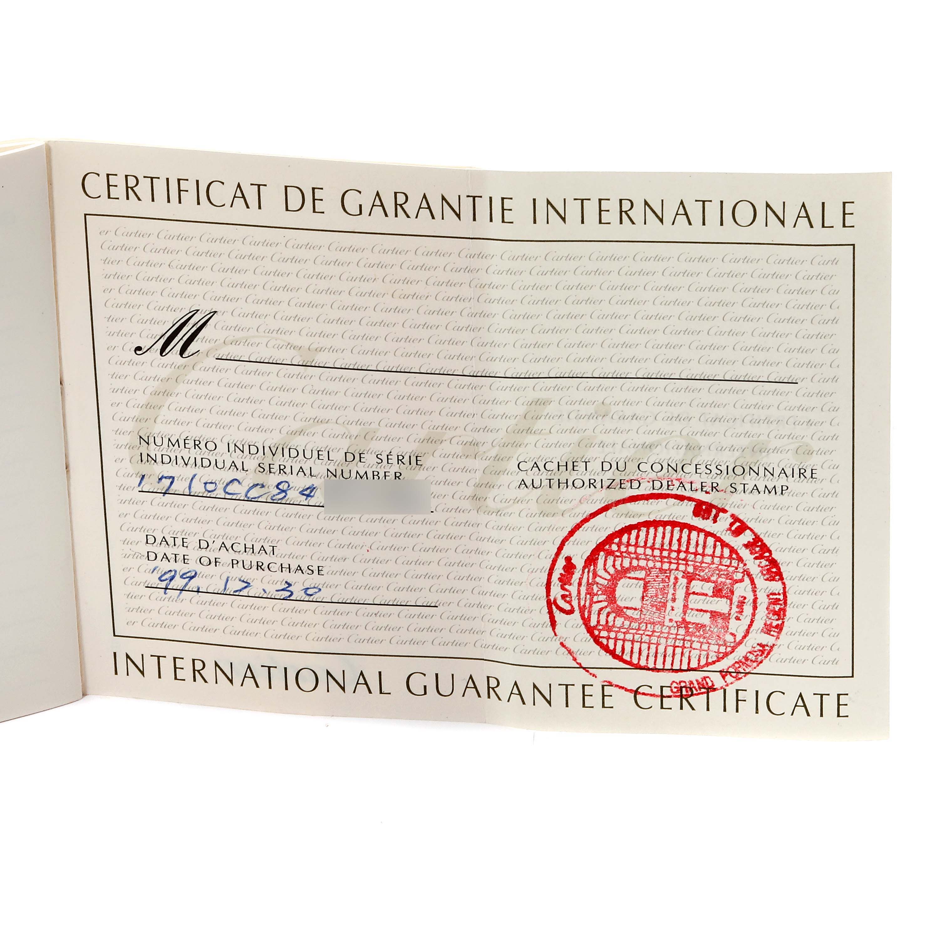 The image shows an International Guarantee Certificate for the Cartier Tank Americaine WB7012K2 Women's Yellow Gold Silver Dial WB7012K2 Women's Yellow Gold Silver Dial model with serial number and dealer stamp visible.