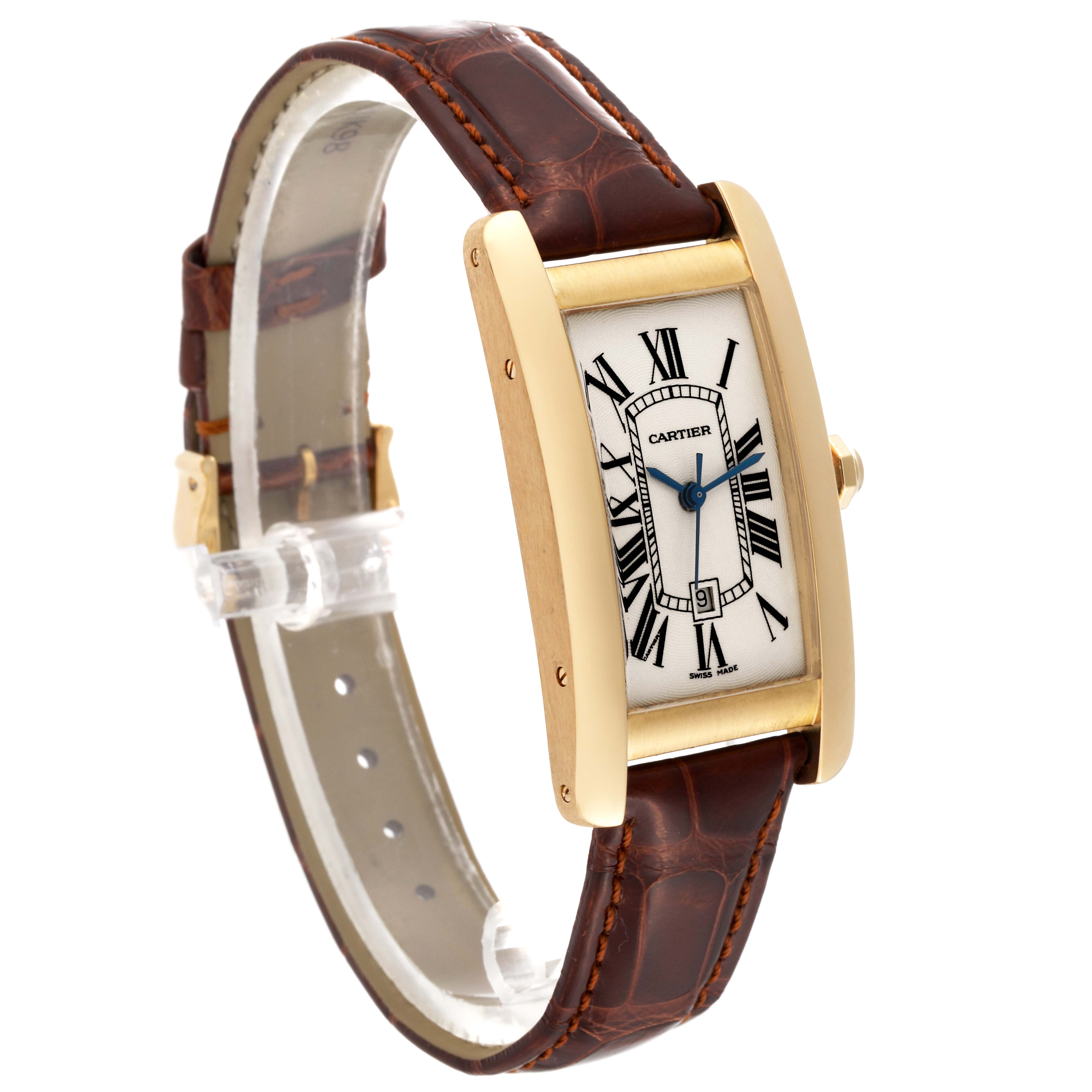 The image shows a Cartier Tank Americaine W2603556 Men's Yellow Gold Silver Dial W2603556 Men's Yellow Gold Silver Dial watch with a gold case and brown leather strap at a three-quarter angle.