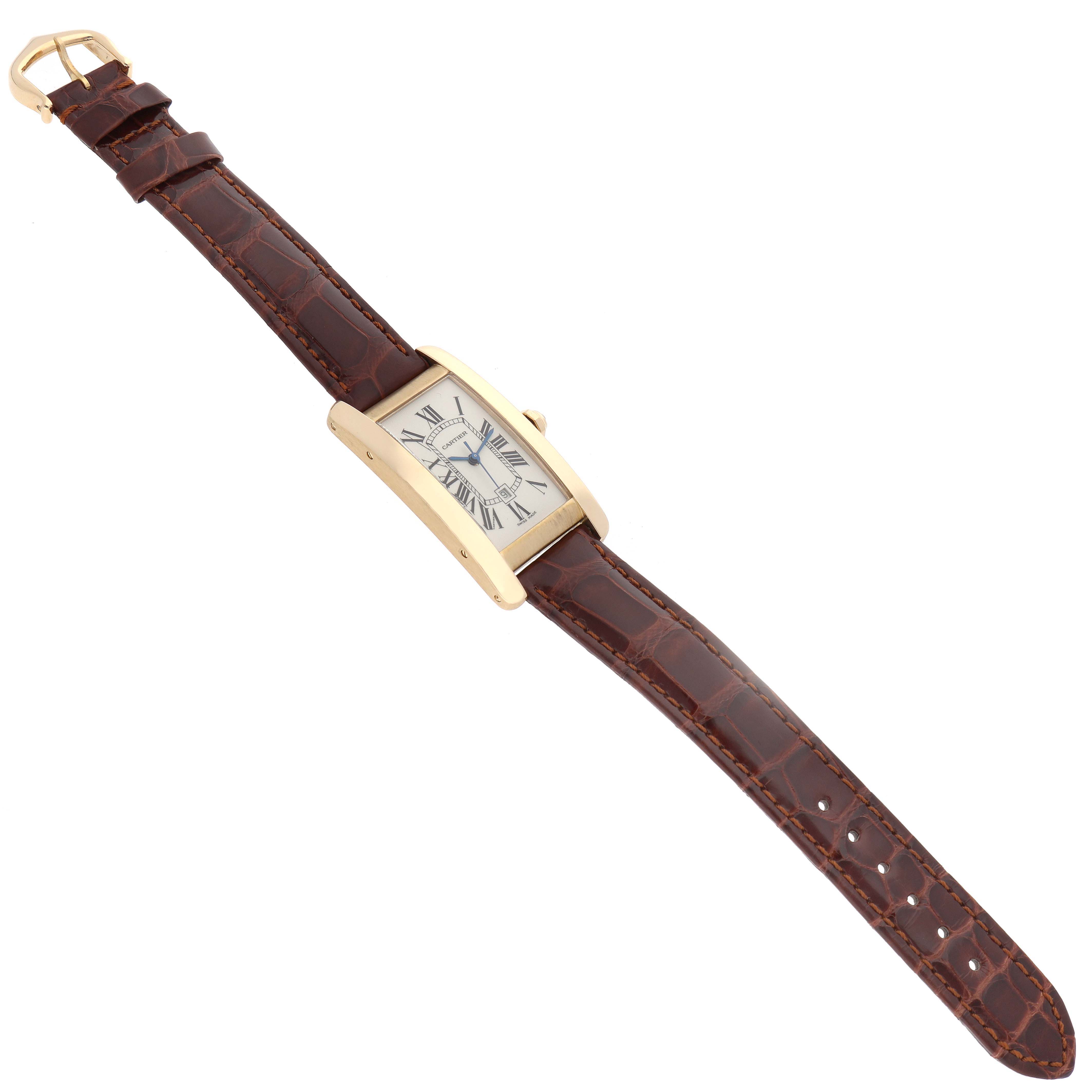 The Cartier Tank Americaine W2603556 Men's Yellow Gold Silver Dial W2603556 Men's Yellow Gold Silver Dial watch is shown from a top-down angle, featuring the full face and brown leather strap.