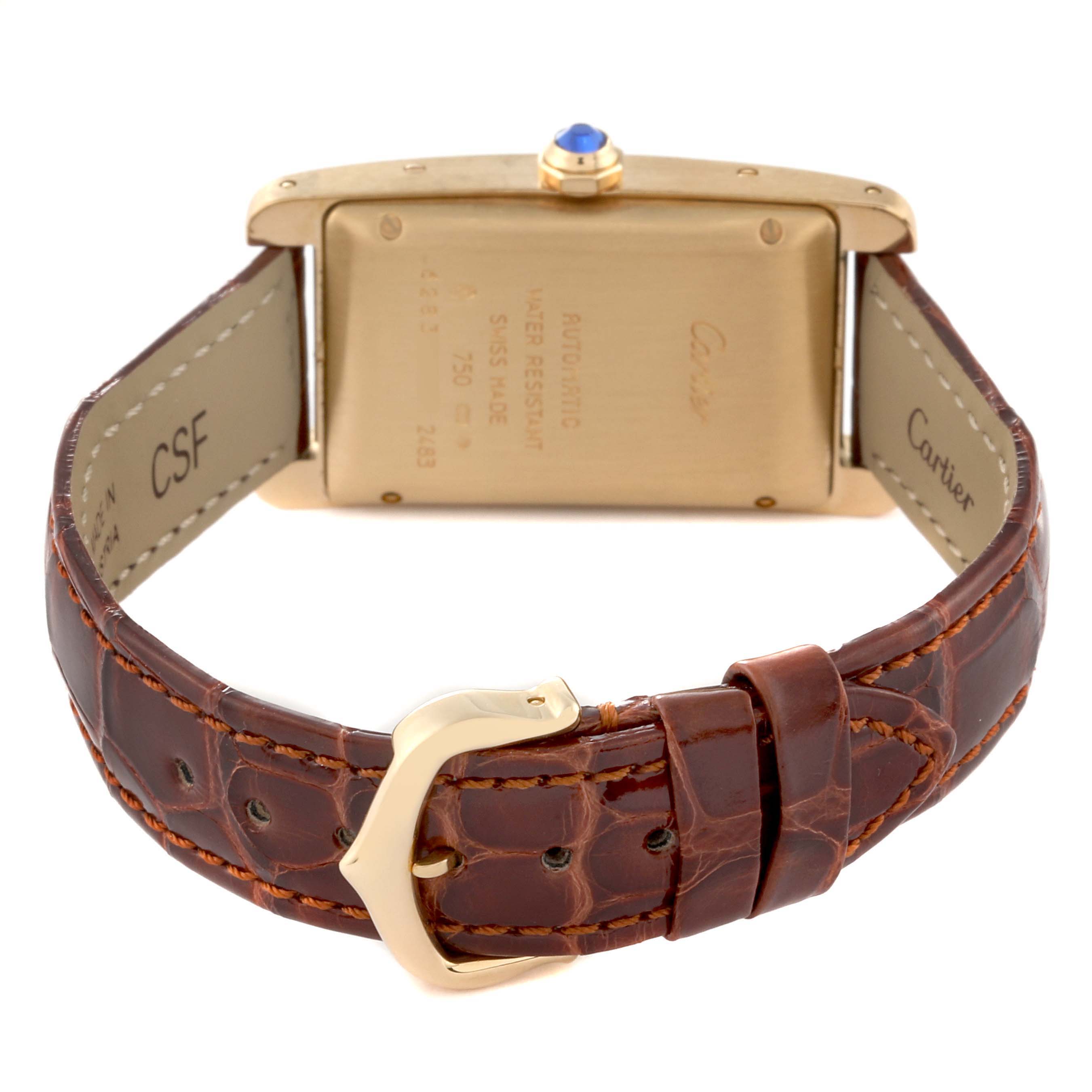 The image shows the back view of a Cartier Tank Americaine W2603556 Men's Yellow Gold Silver Dial W2603556 Men's Yellow Gold Silver Dial watch, highlighting the case back, buckle, and leather strap.