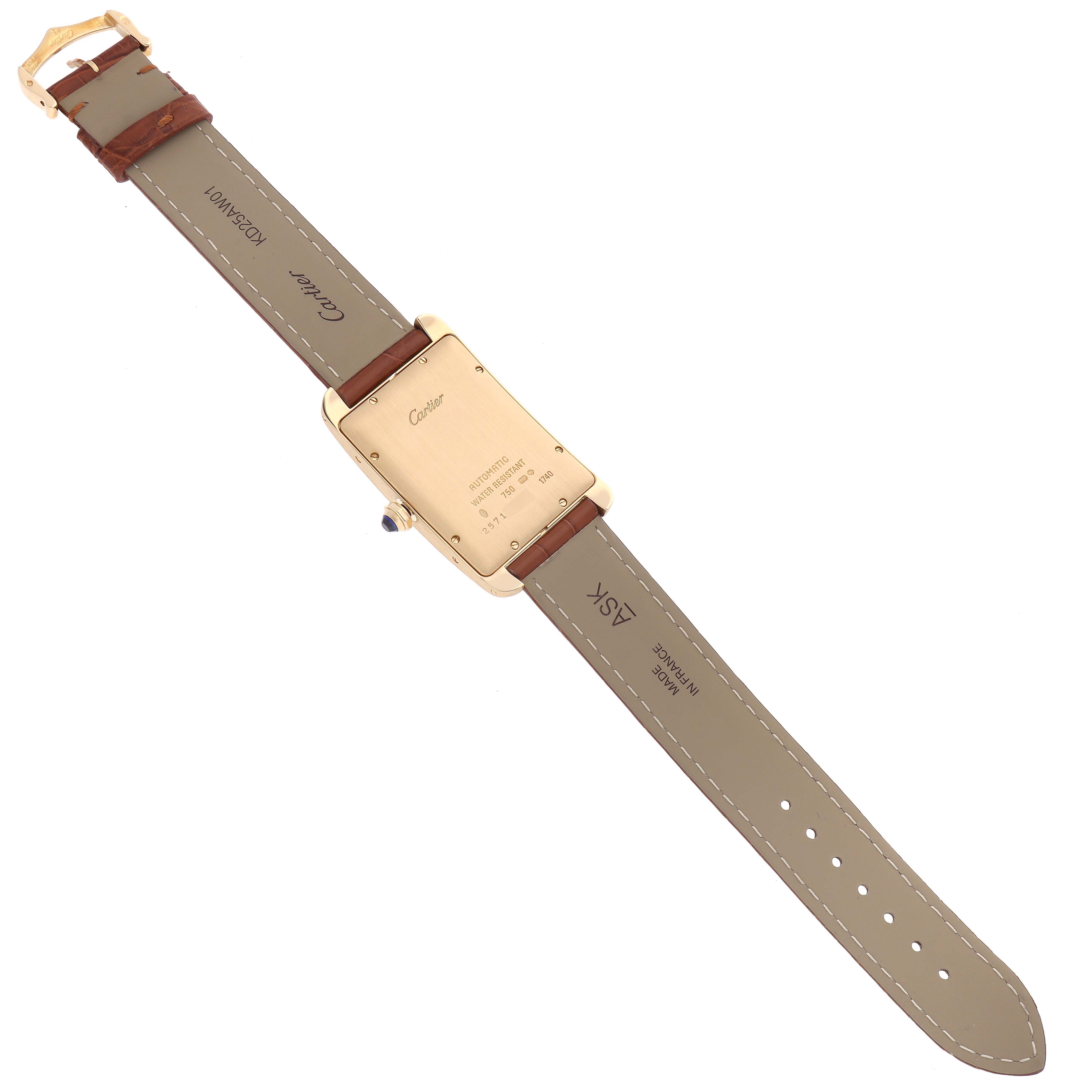 The image shows the back of a Cartier Tank Americaine W2603156 Men's Yellow Gold Silver Dial W2603156 Men's Yellow Gold Silver Dial watch, displaying its brown leather straps and gold caseback.