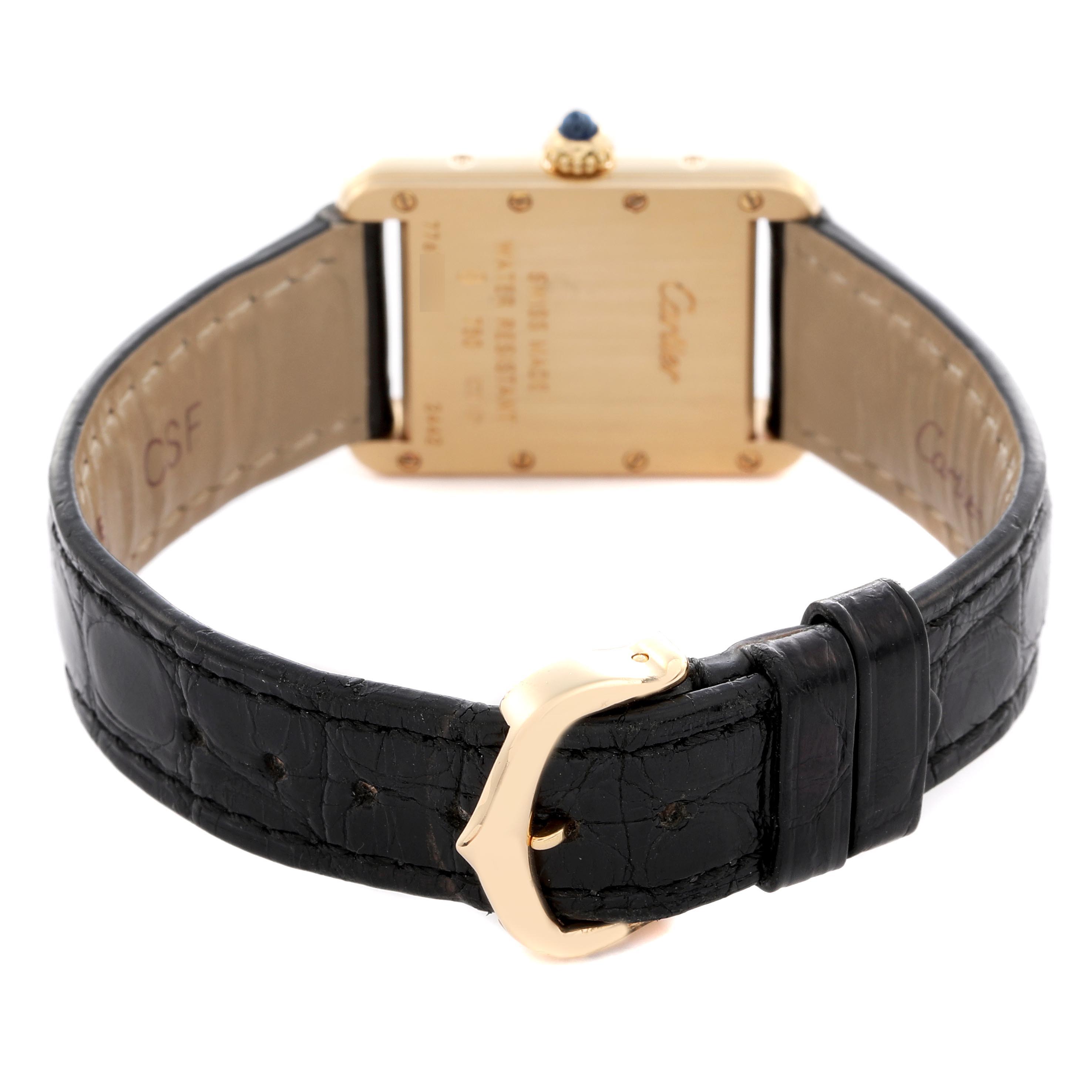 The image shows the back of a Cartier Tank Louis W1529856 Women
s Yellow Gold Silver Dial W1529856 Women
s Yellow Gold Silver Dial watch, highlighting the gold clasp and black leather strap.