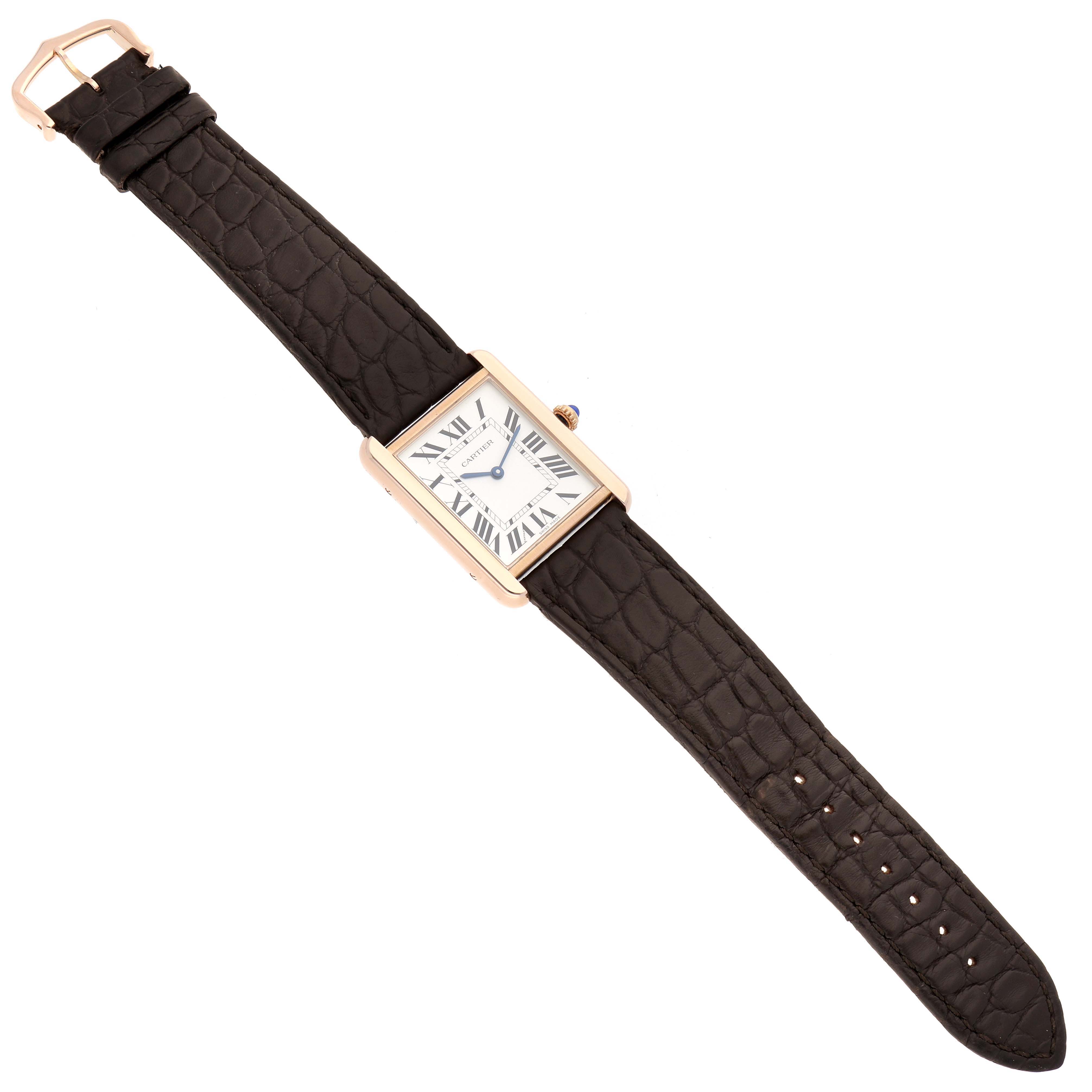 The Cartier Tank Solo W5200025 Men's Rose Gold Silver Dial W5200025 Men's Rose Gold Silver Dial watch is shown from a top-down angle, displaying its face and entire leather strap.