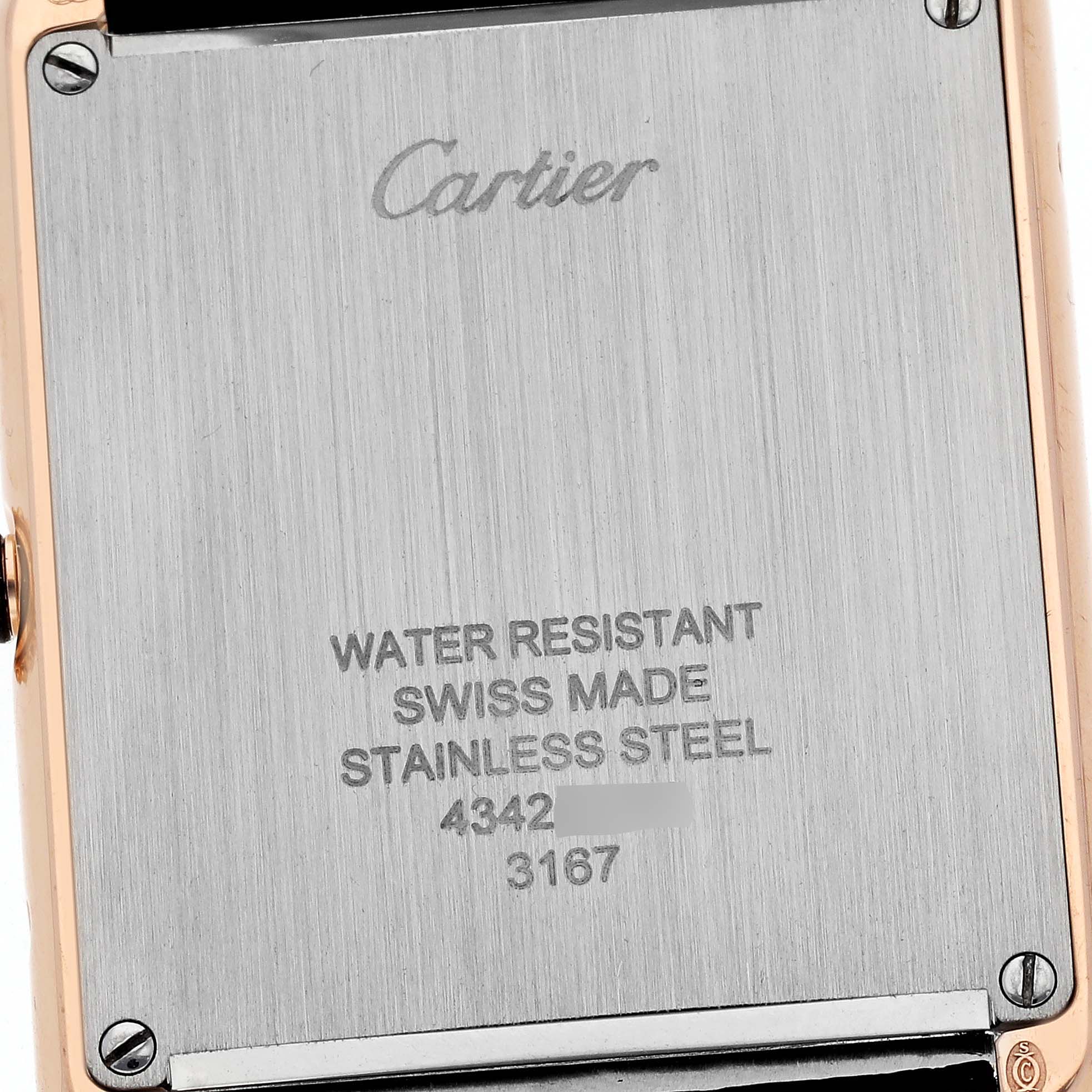 This image shows the back case of a Tank Solo watch by Cartier, highlighting inscriptions and screw details.