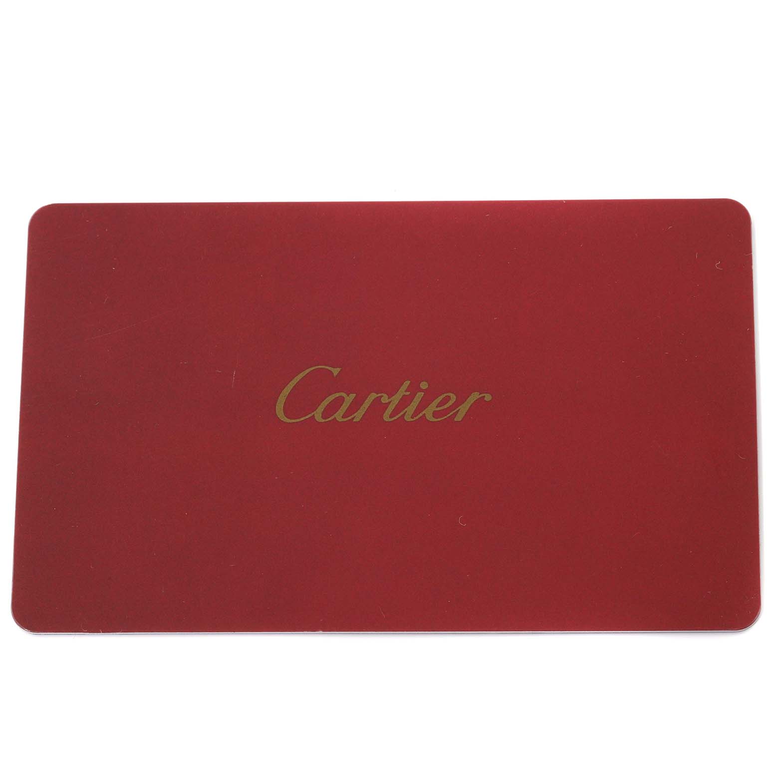 This image shows a red rectangular card with the brand name "Cartier" in gold, likely an accessory for the Cartier Tank Solo W5200025 Men's Rose Gold Silver Dial W5200025 Men's Rose Gold Silver Dial model.
