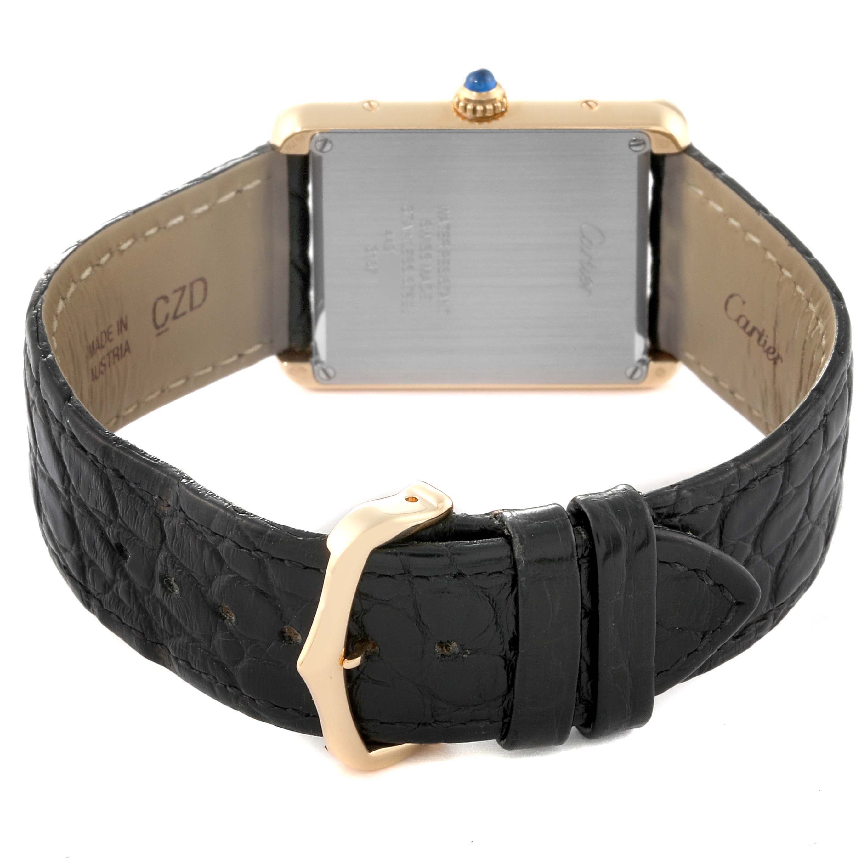 This image shows the back view of a Cartier Tank Solo W5200004 Men's Yellow Gold Silver Dial W5200004 Men's Yellow Gold Silver Dial watch, highlighting its clasp and leather strap.