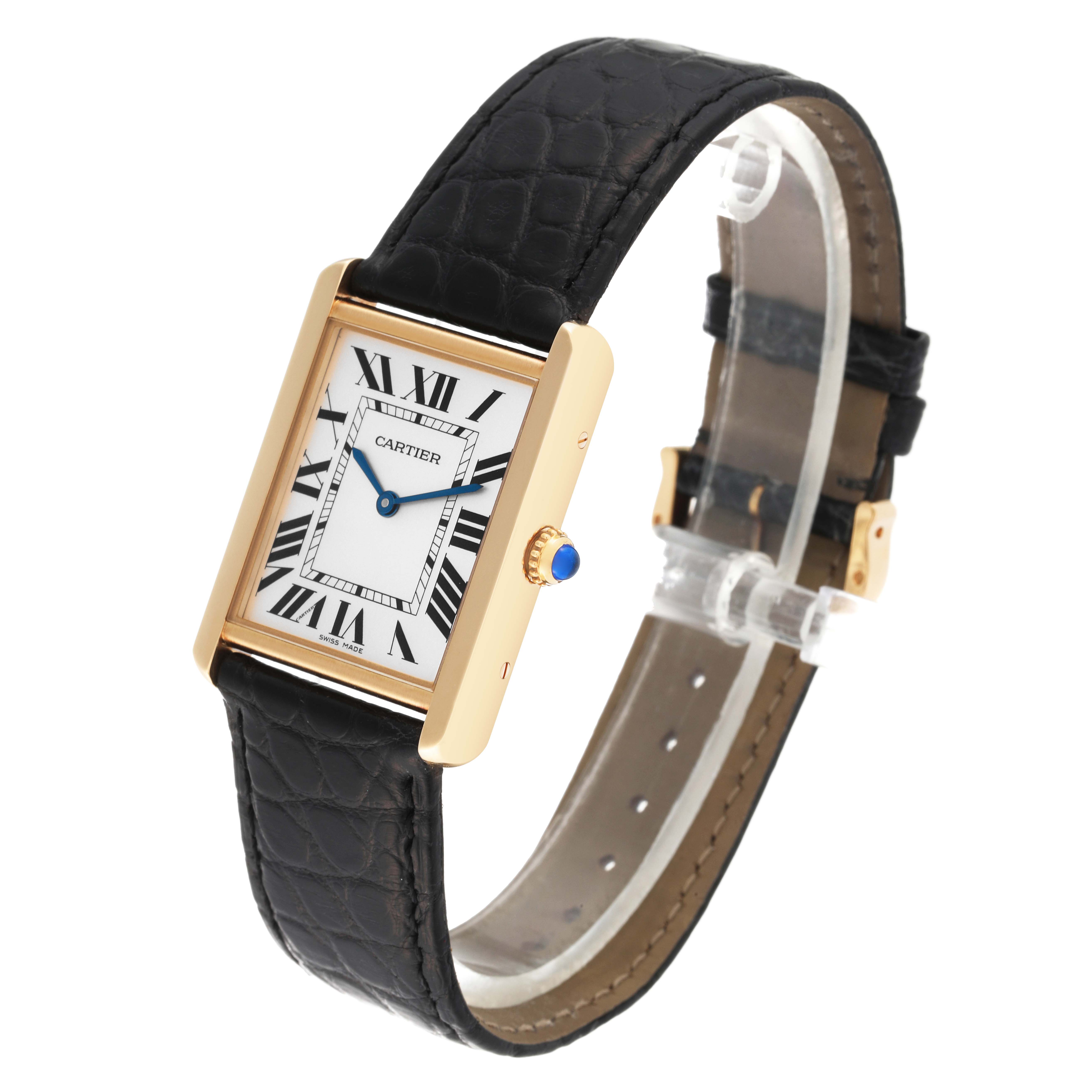 The Cartier Tank Solo W1018855 Men's Yellow Gold Silver Dial W1018855 Men's Yellow Gold Silver Dial watch is angled to show its face, black leather strap, and side view with a blue cabochon crown.