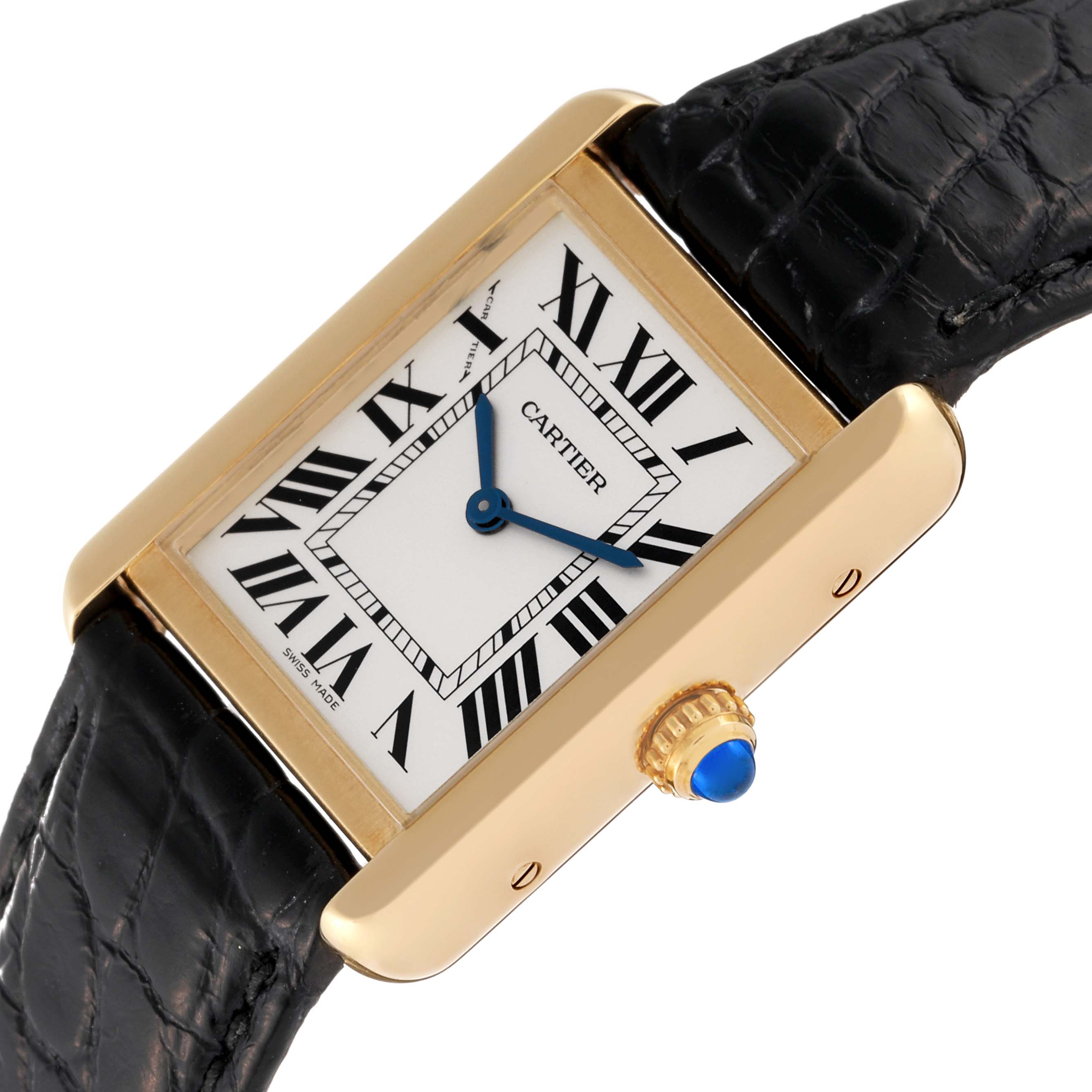 The Cartier Tank Solo W5200002 Women
s Yellow Gold Silver Dial W5200002 Women
s Yellow Gold Silver Dial watch is shown from an angled top view, displaying its rectangular face, Roman numerals, blue hands, and black strap.