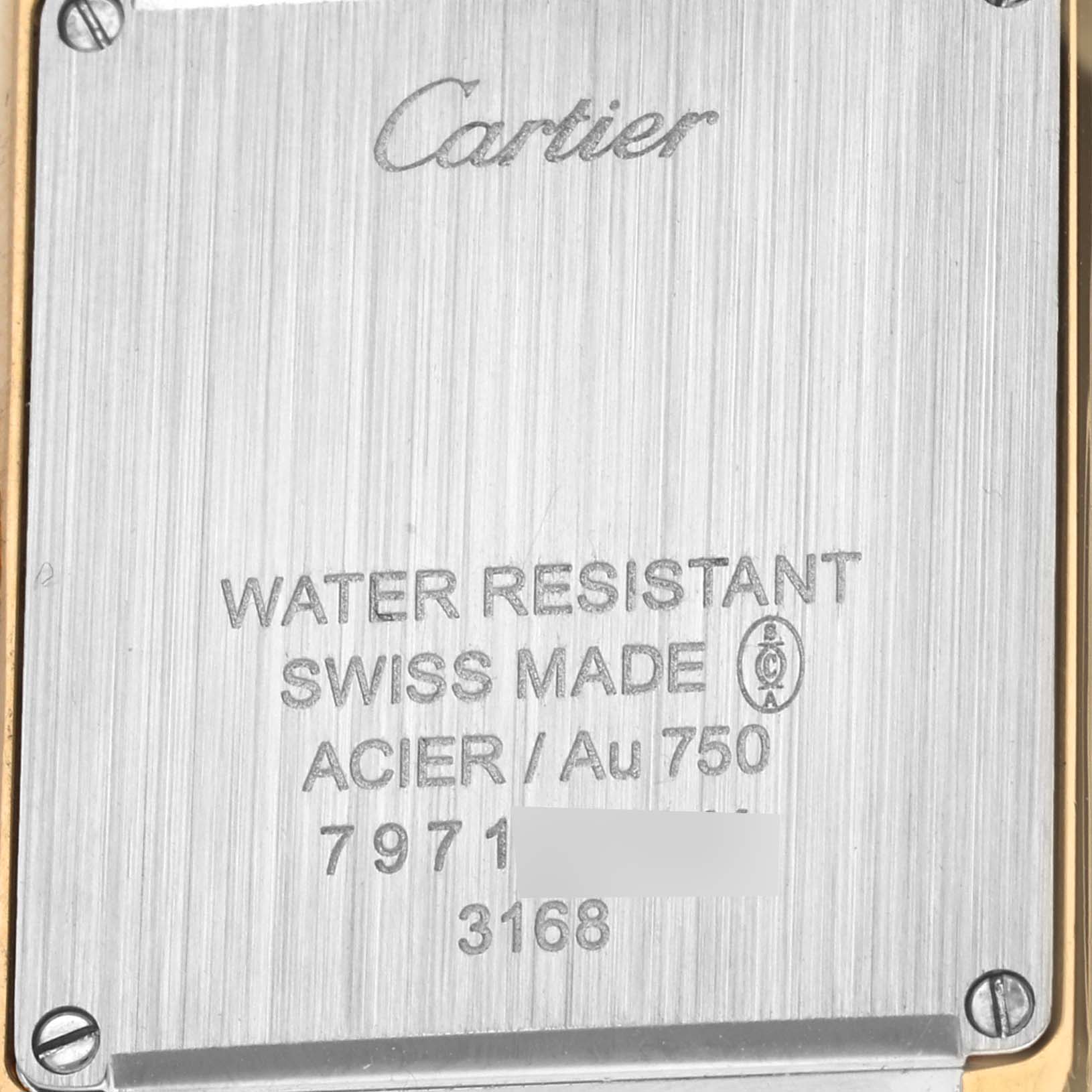 The image shows the back case of a Cartier Tank Solo W5200002 Women's Yellow Gold Silver Dial W5200002 Women's Yellow Gold Silver Dial watch, displaying branding and specifications.