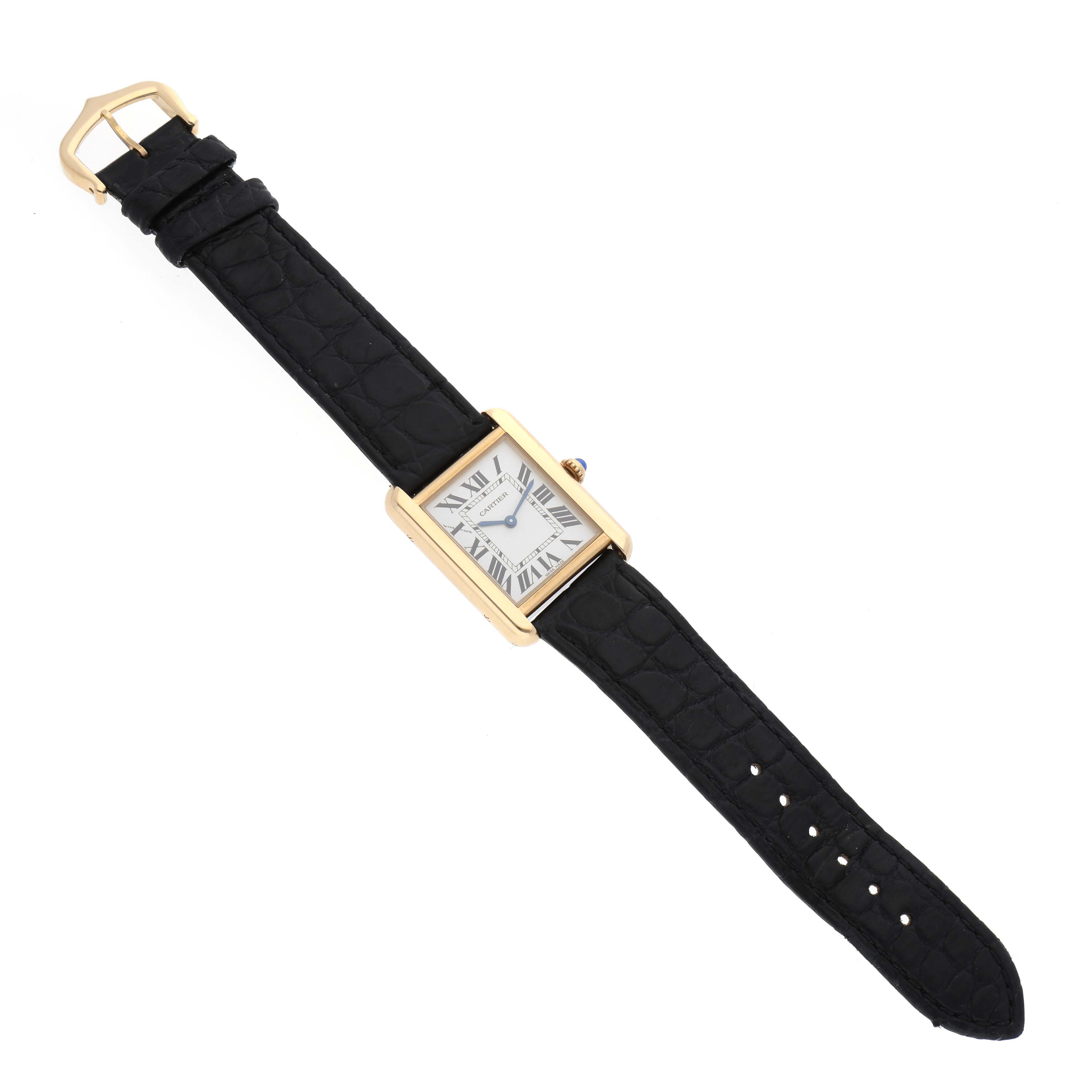The Cartier Tank Solo W5200002 Women's Yellow Gold Silver Dial W5200002 Women's Yellow Gold Silver Dial watch is shown from a top-down angle, featuring its gold rectangular case and black leather strap.