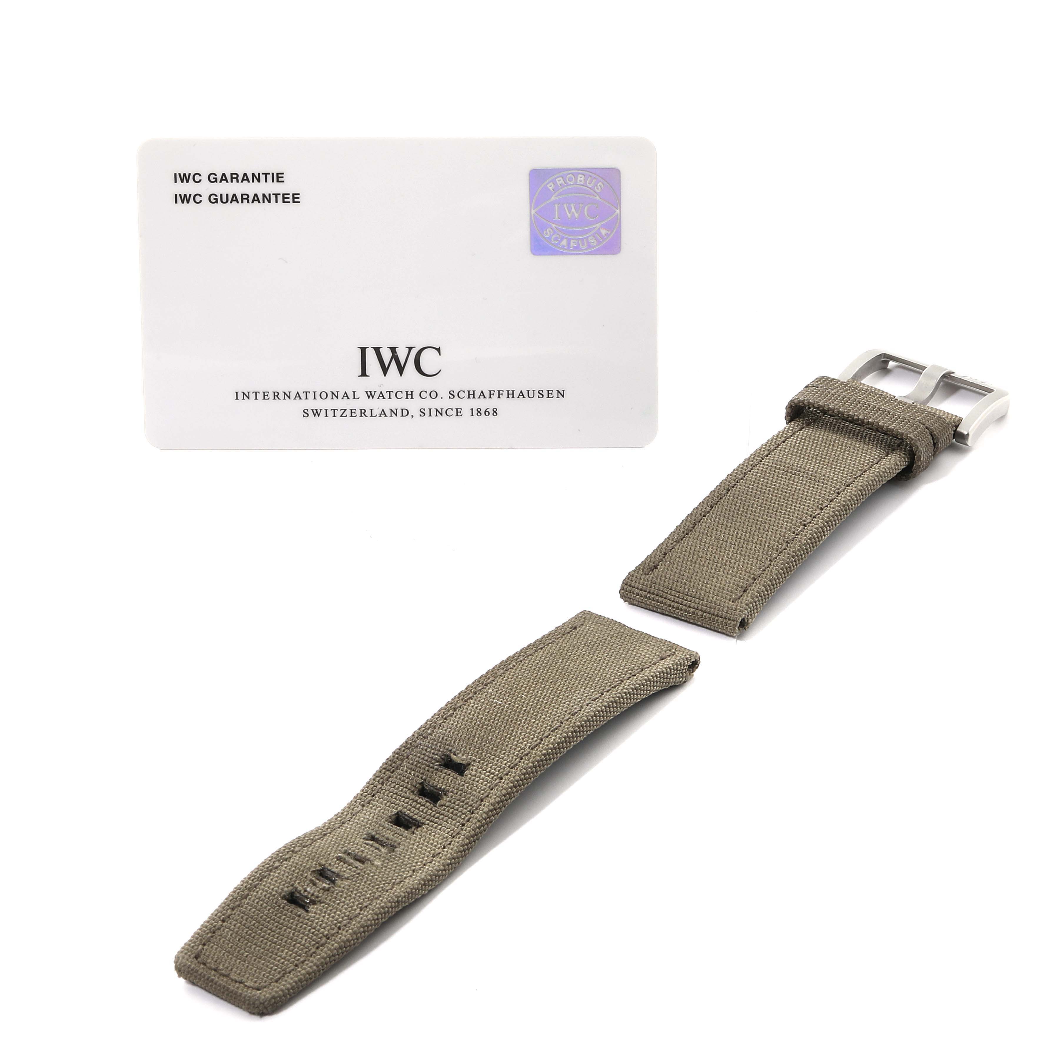 The image shows the front side of the IWC Pilot IW501902 Men's Ceramic Grey Dial IW501902 Men's Ceramic Grey Dial watch's gray fabric strap and IWC guarantee card.