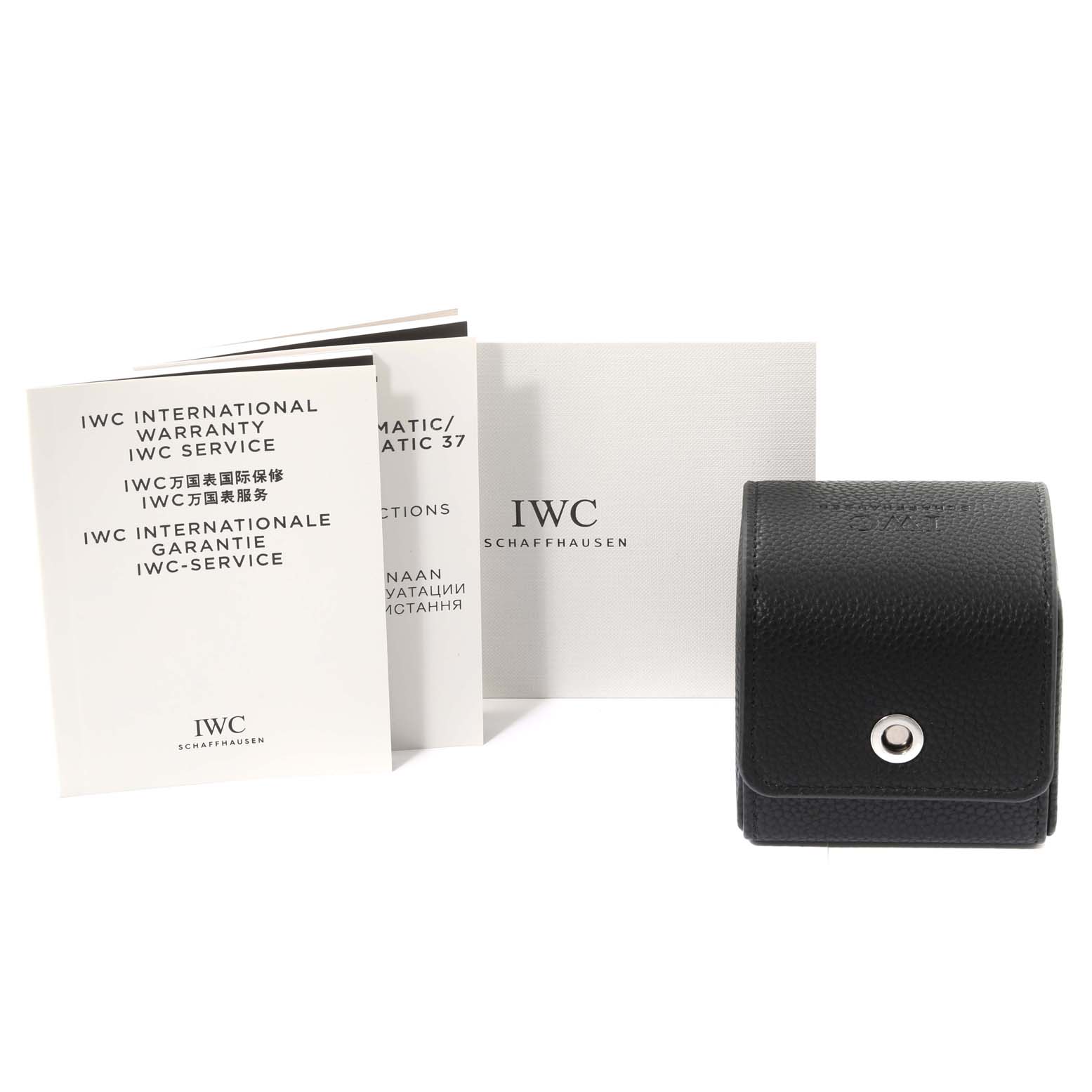 The image shows manuals, warranty cards, and a black leather travel case for the IWC Portuguese IW3711205 Men's Platinum Silver Dial IW3711205 Men's Platinum Silver Dial model watch.