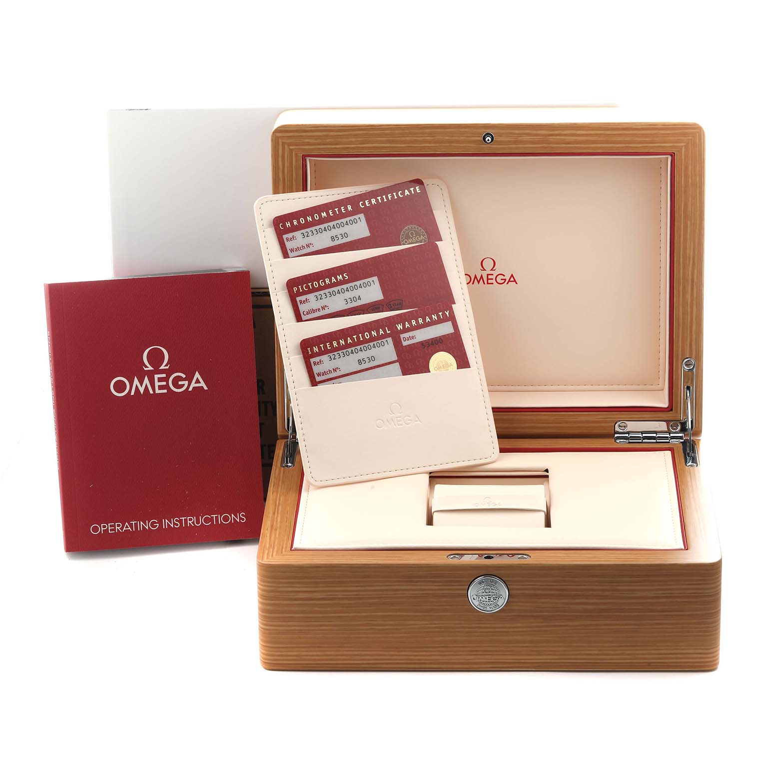 The image shows an Omega Speedmaster 323.30.40.40.04.001 Men
s Stainless Steel Silver Dial 323.30.40.40.04.001 Men
s Stainless Steel Silver Dial watch box, warranty cards, and an instruction manual from a front angle.