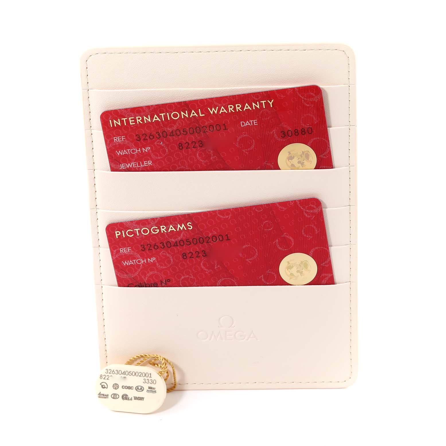 The image shows an international warranty card, pictograms card, and an Omega Speedmaster 326.30.40.50.02.001 Men
s Stainless Steel Silver Dial 326.30.40.50.02.001 Men
s Stainless Steel Silver Dial model tag in a holder.