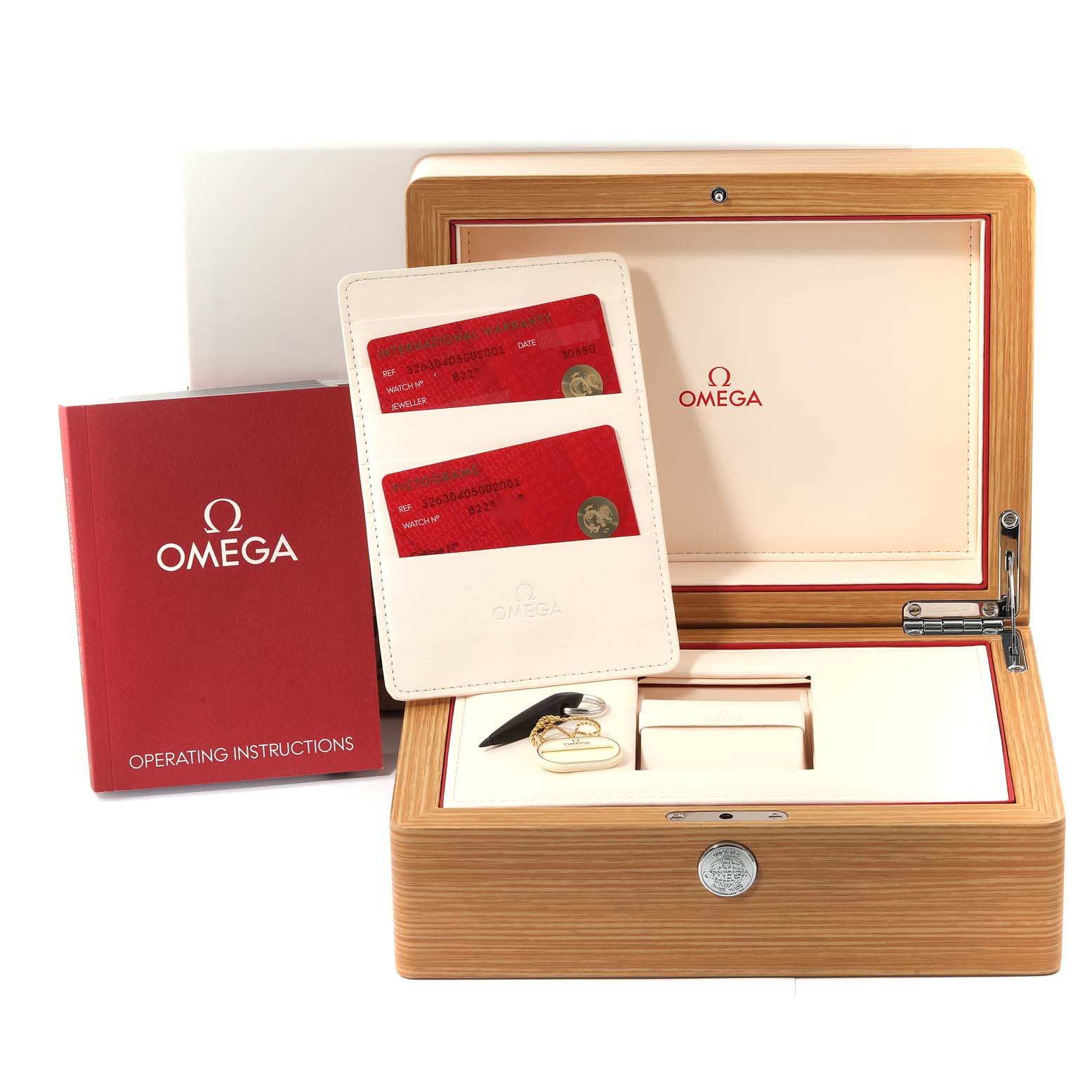 The image shows the Omega Speedmaster 326.30.40.50.02.001 Men
s Stainless Steel Silver Dial 326.30.40.50.02.001 Men
s Stainless Steel Silver Dial watch packaging, including the wooden box, operating instructions, and warranty cards.