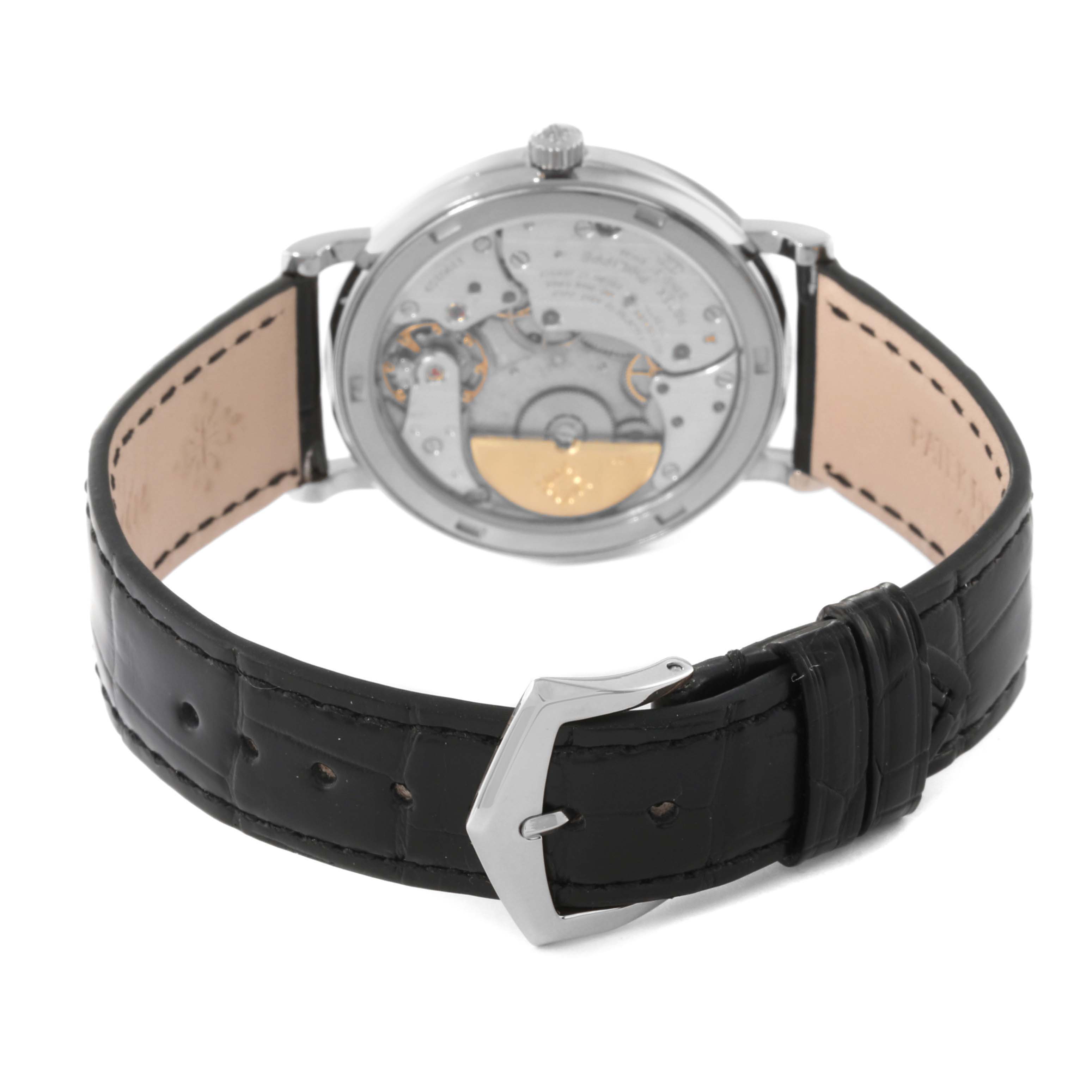 This image shows the back view of the Patek Philippe Calatrava 5120 Men
s White Gold White Dial 5120 Men
s White Gold White Dial watch, displaying its intricate mechanical movement and black leather strap.