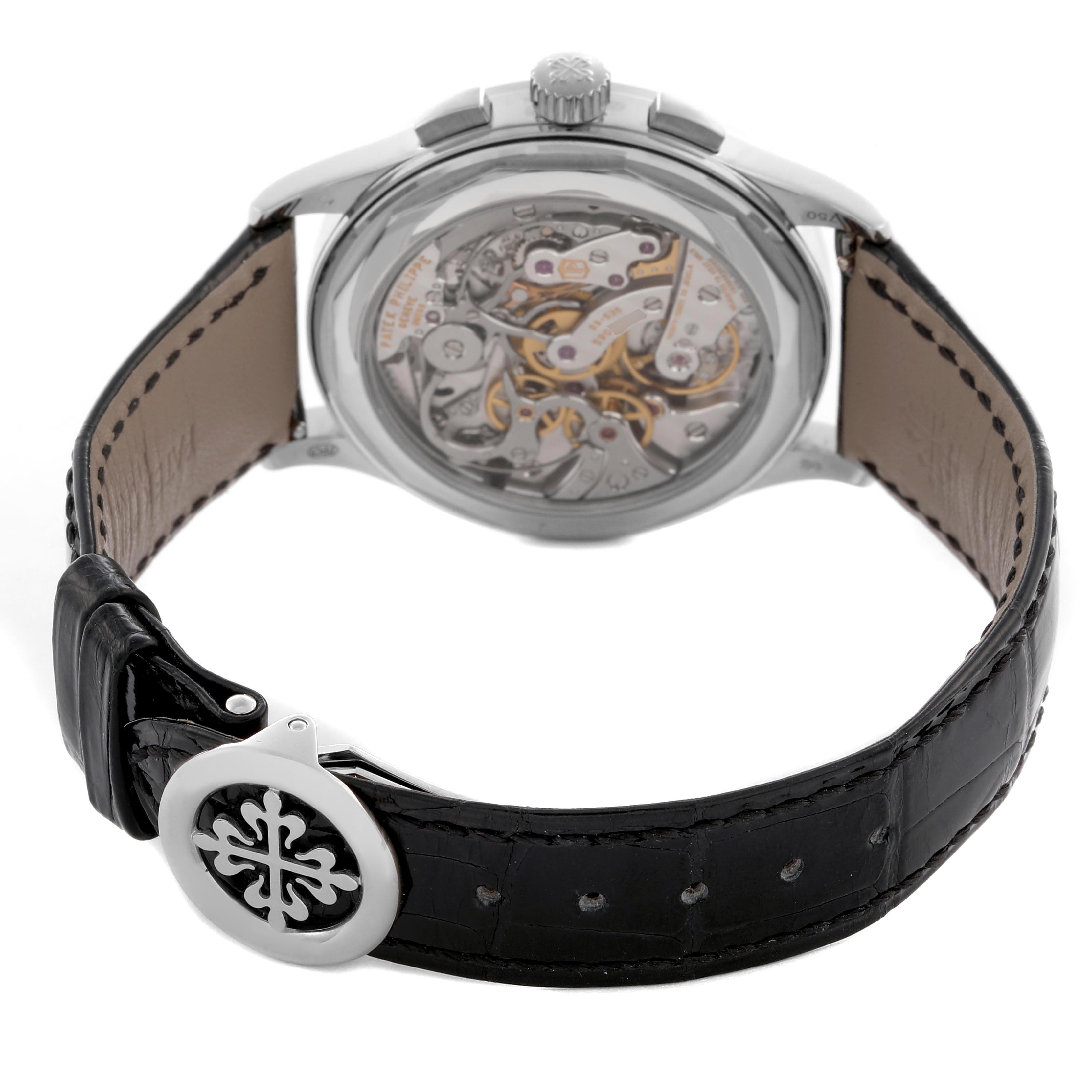 The image shows the back of a Patek Philippe Complications 5170G-010 Men
s White Gold Black Dial 5170G-010 Men
s White Gold Black Dial watch, highlighting the movement and leather strap with buckle.