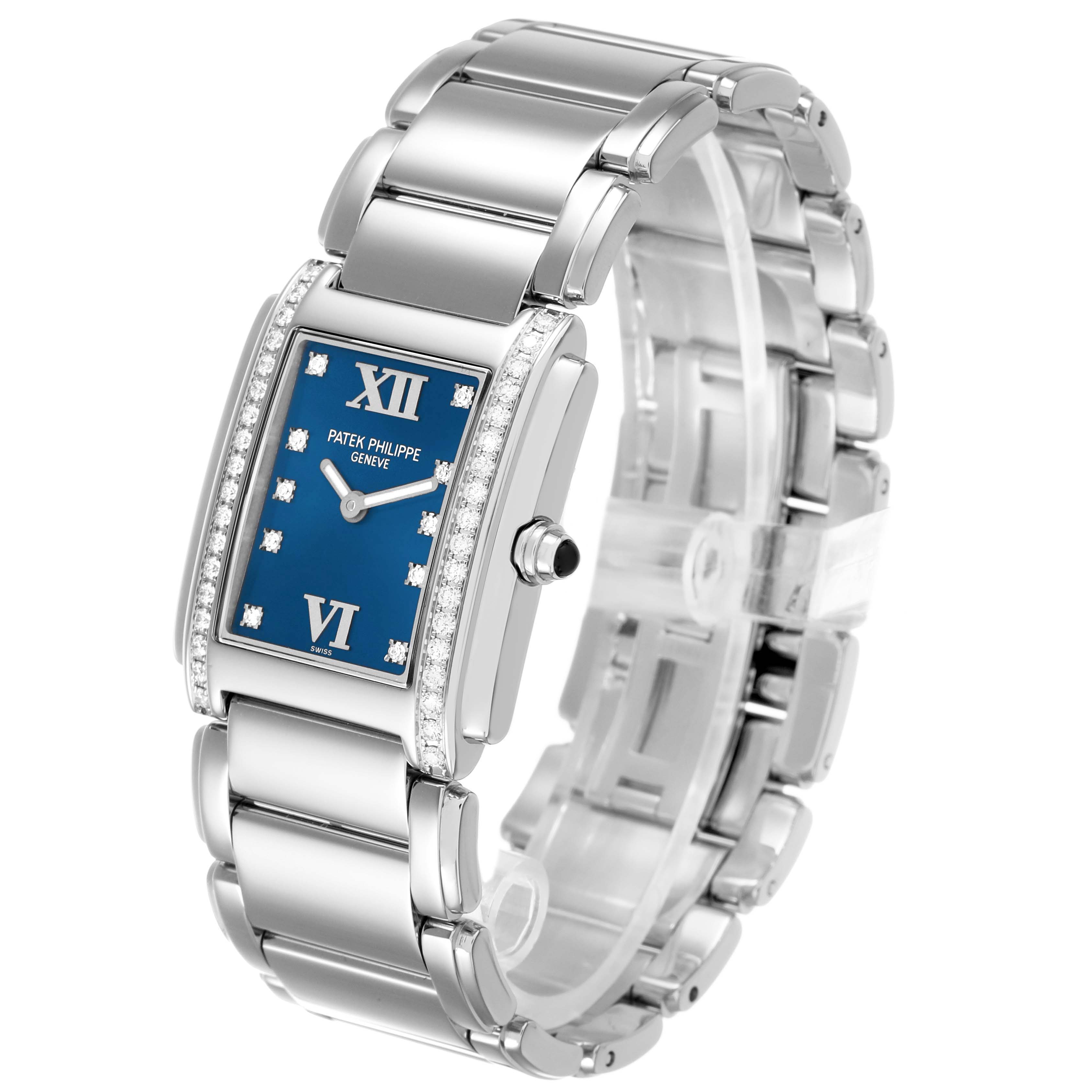 The Patek Philippe Twenty-4 4910 4910A Women's Stainless Steel Blue Dial watch is shown at an angle revealing its blue dial, side crown, and silver bracelet.