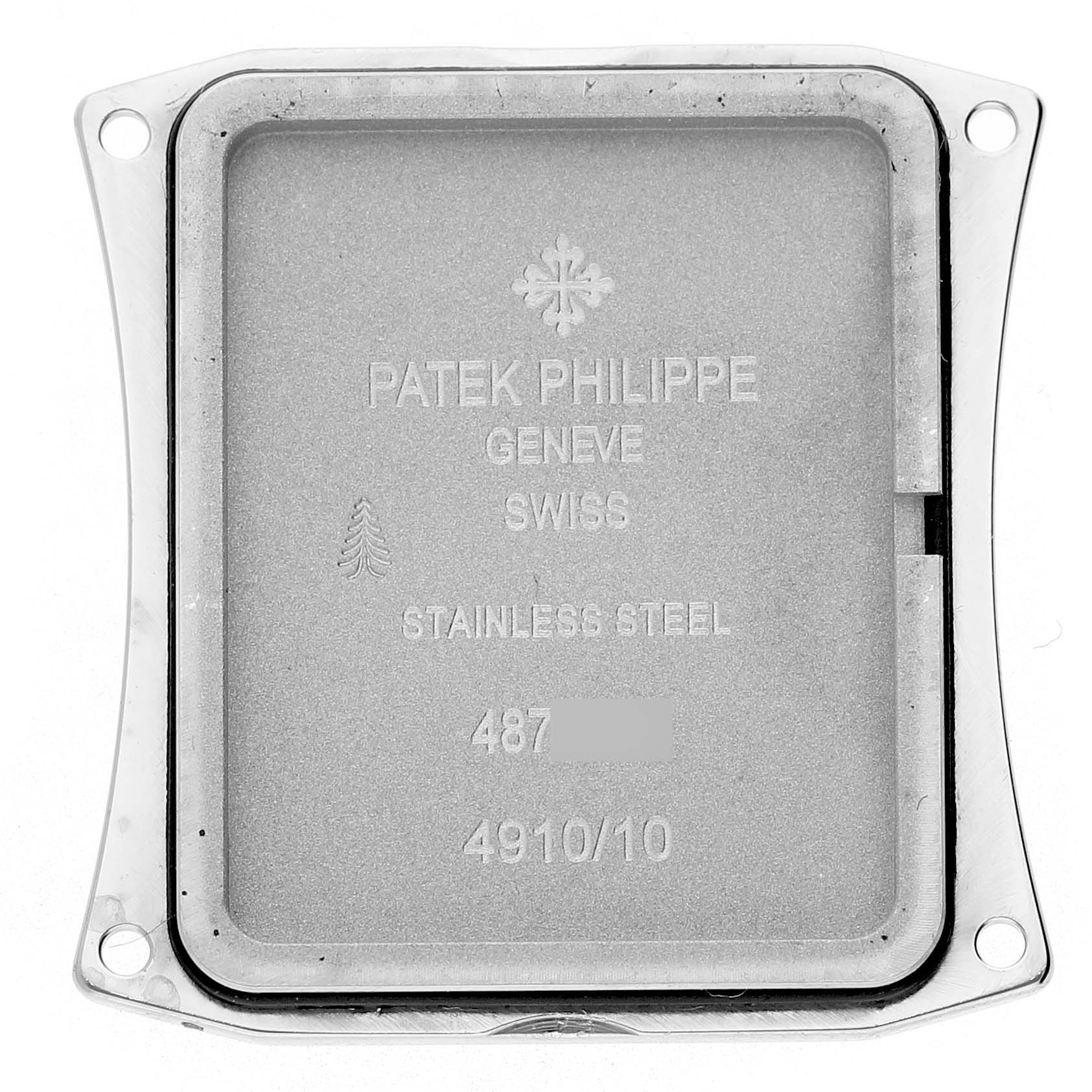 The image shows the backplate of a Patek Philippe Twenty-4 4910 4910A Women's Stainless Steel Blue Dial watch, highlighting engraved details and the stainless steel material.