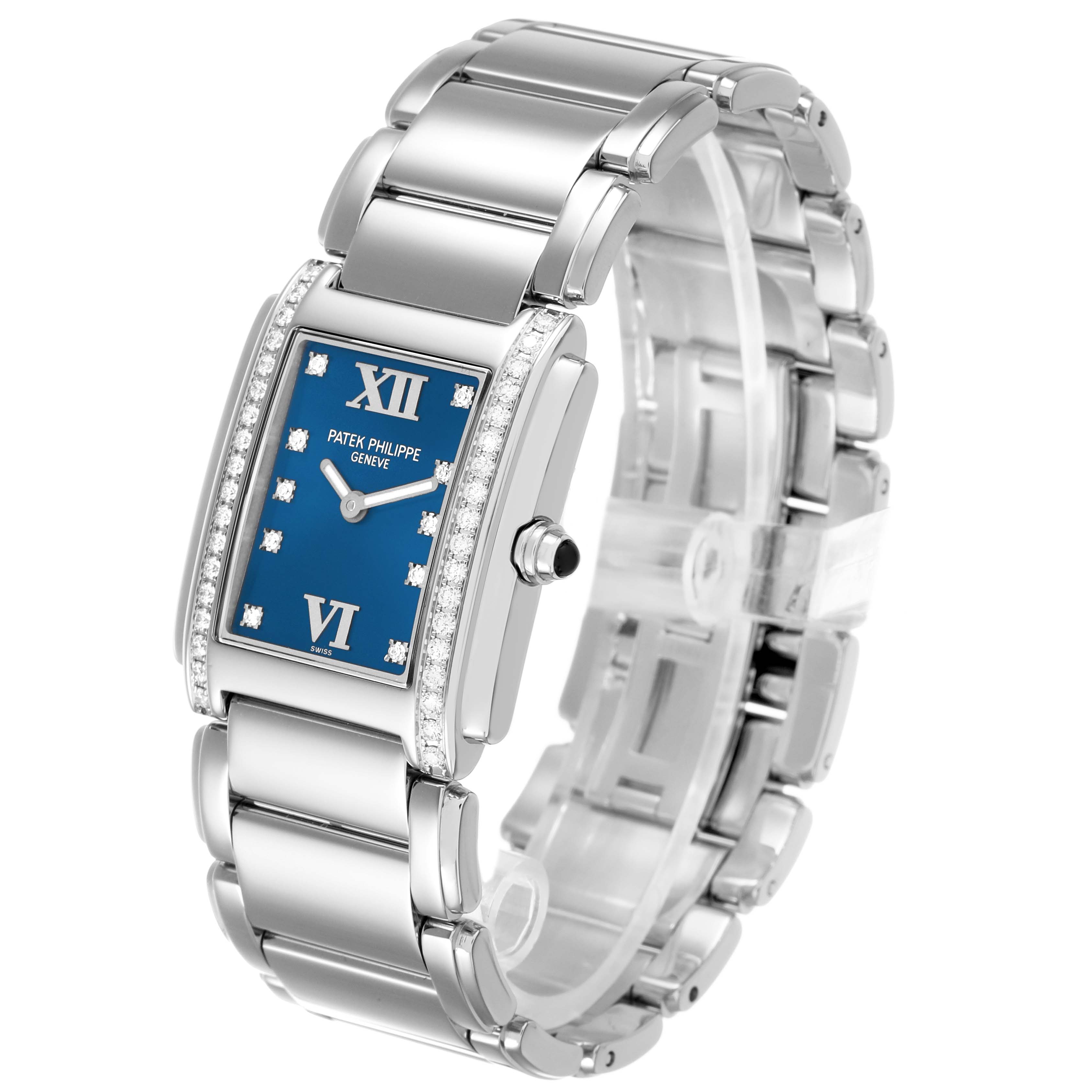 The Patek Philippe Twenty-4 4910 4910A Women's Stainless Steel Blue Dial watch is shown at a 3/4 angle, displaying the bracelet, face, and diamond-set bezel.