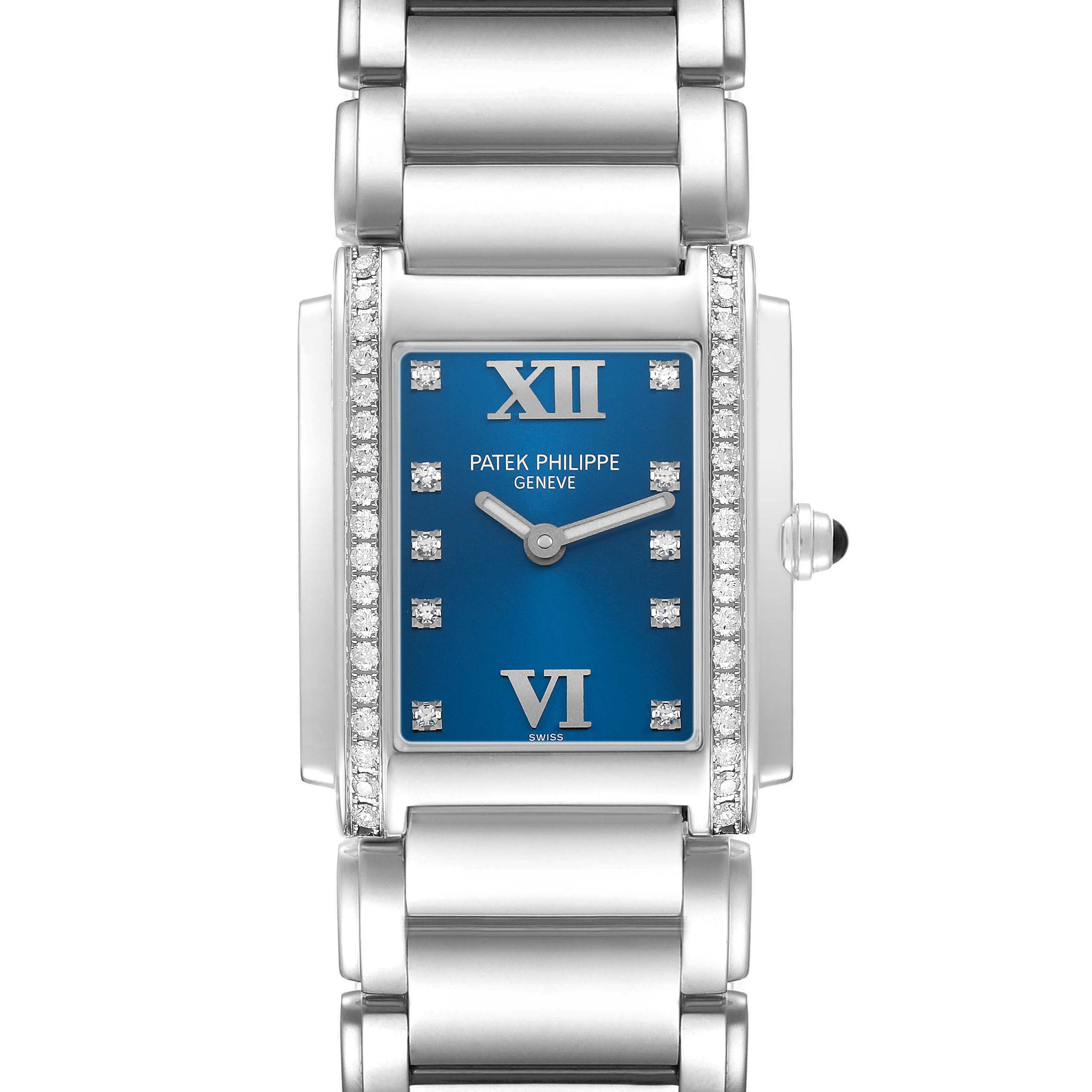 The Patek Philippe Twenty-4 4910 4910A Women's Stainless Steel Blue Dial watch is shown from a top-down angle, displaying its blue dial, Roman numerals, diamond accents, and metal bracelet.
