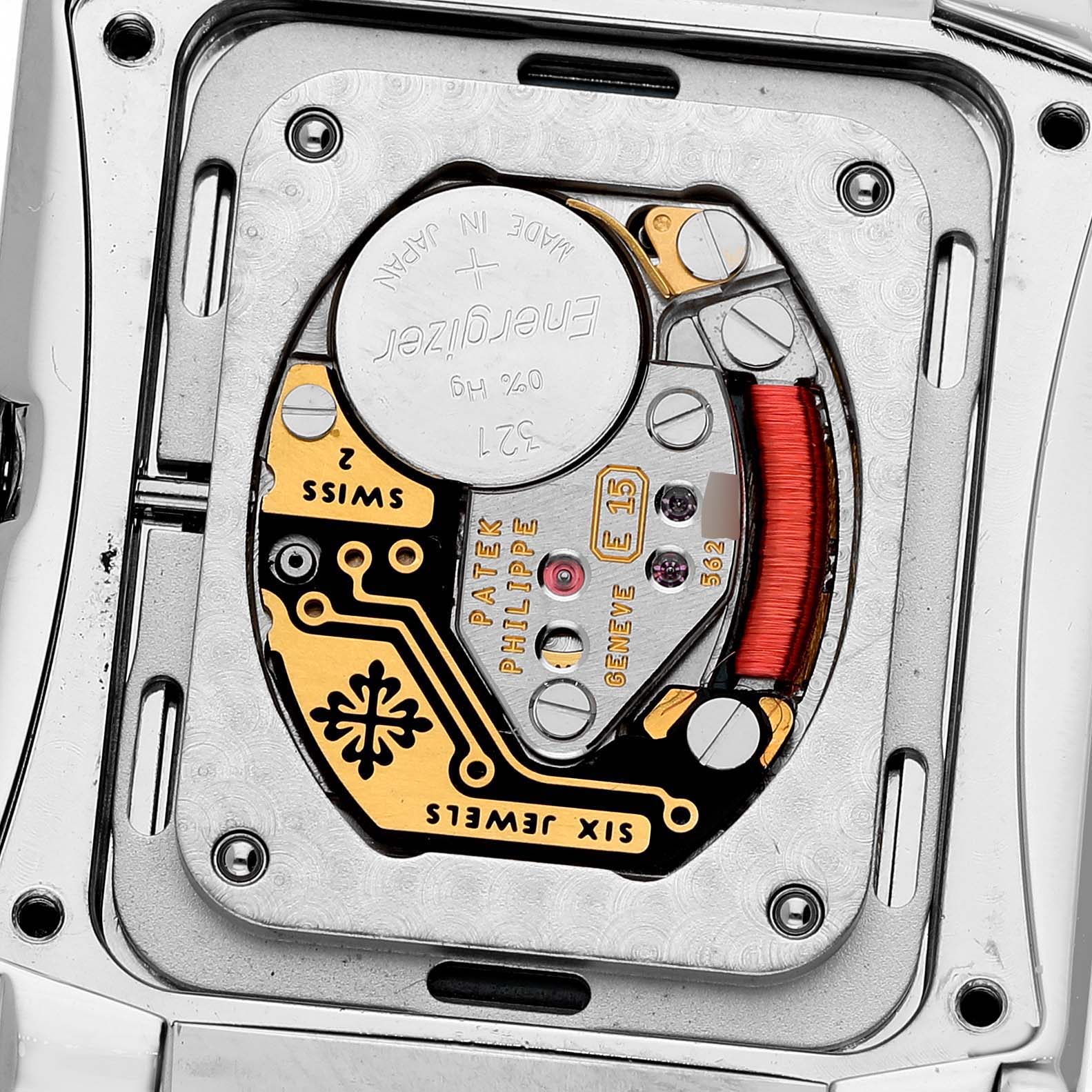 The image shows the movement of a Patek Philippe Twenty-4 4910 4910A Women's Stainless Steel Blue Dial watch from the back, highlighting the intricate mechanisms and battery.
