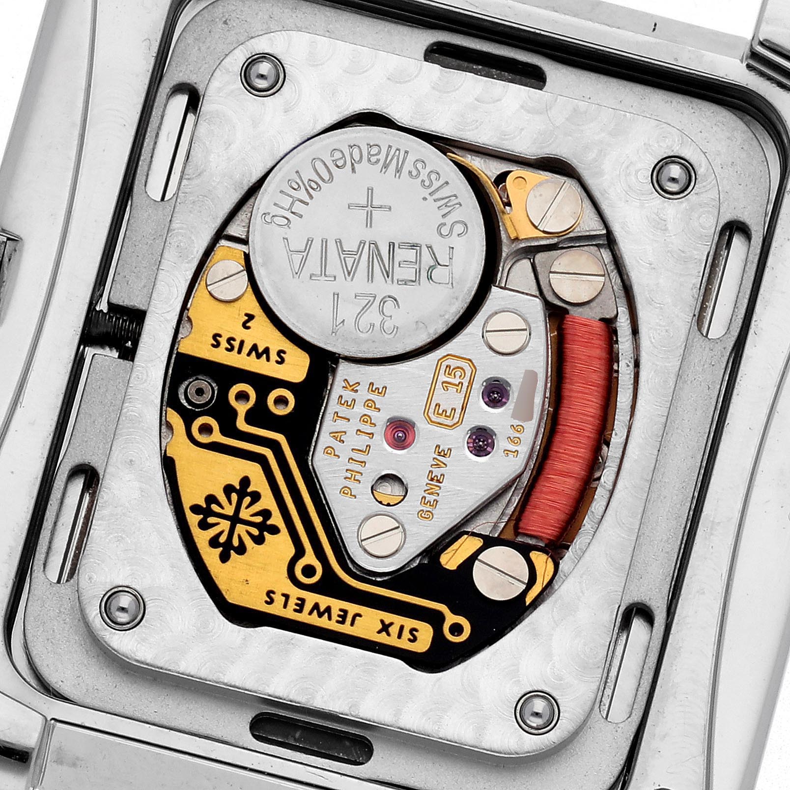 The image shows the back view of a Patek Philippe Twenty-4 4910 Women
s Stainless Steel Silver Dial 4910 Women
s Stainless Steel Silver Dial, highlighting the movement and battery compartment.