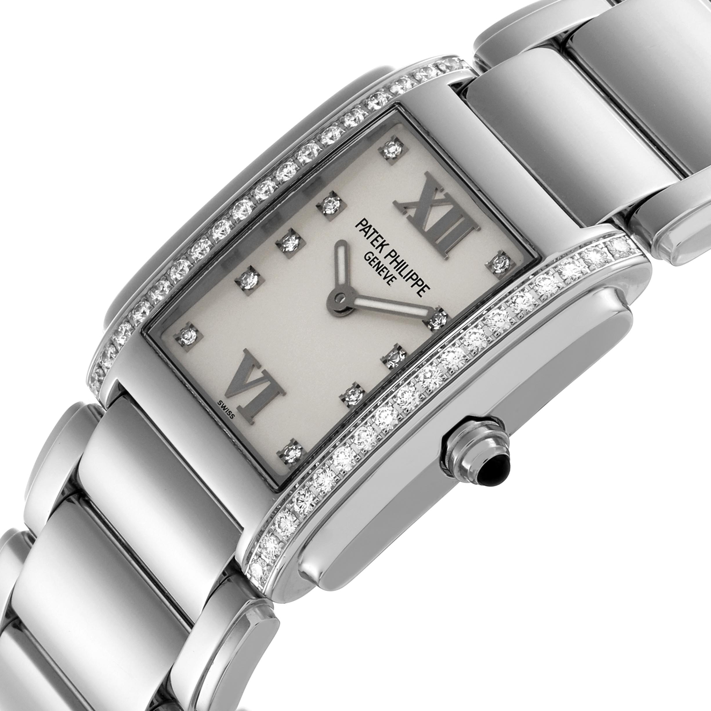 The Patek Philippe Twenty-4 4910 Women
s Stainless Steel Silver Dial 4910 Women
s Stainless Steel Silver Dial watch is shown at an angled view, highlighting the diamond-studded bezel, rectangular face, and part of the bracelet.