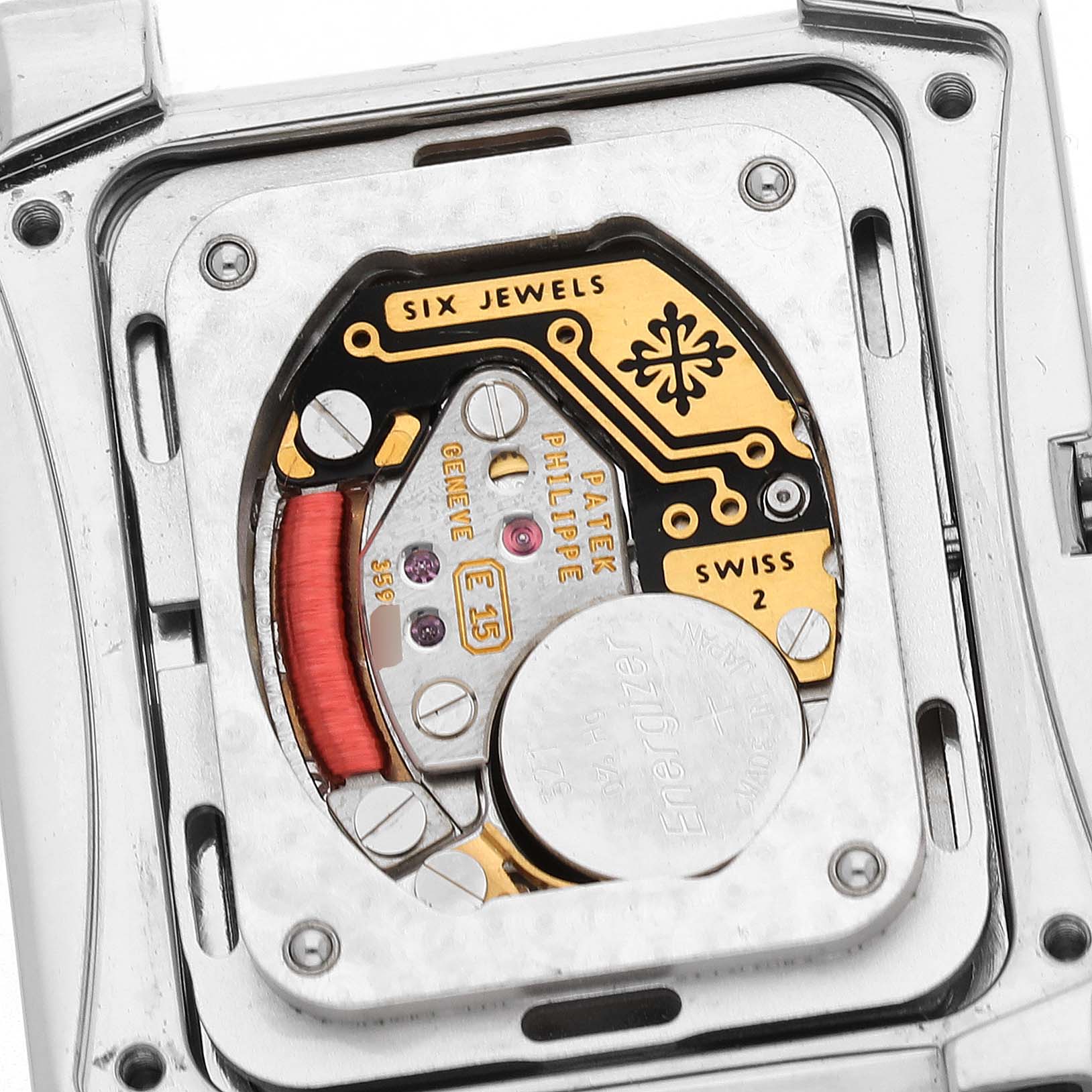 The image shows the back of a Patek Philippe Twenty-4 4910/10A-011 Women's Stainless Steel Silver Dial model, revealing its intricate movement and battery.