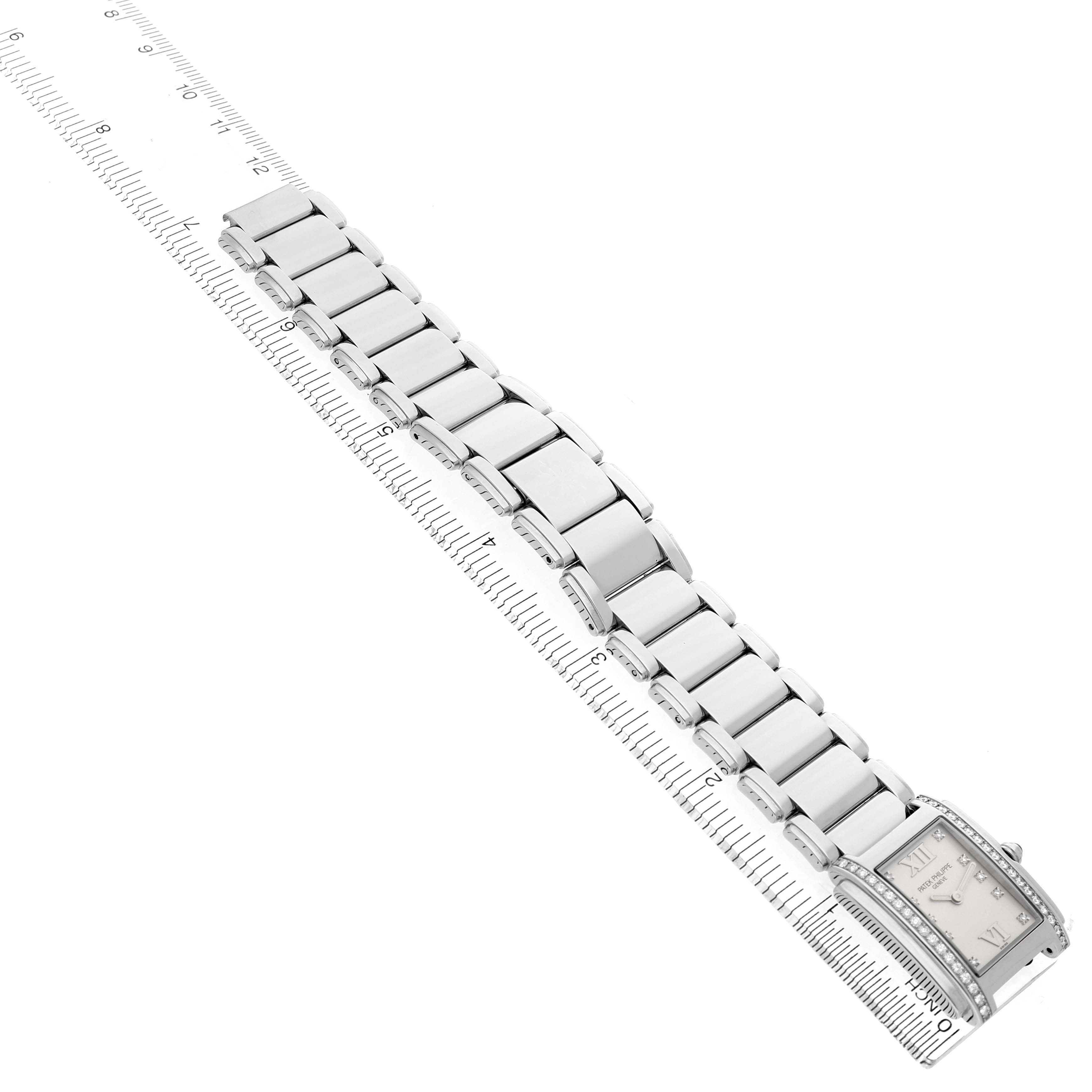 The image shows a side angle of the Patek Philippe Twenty-4 4910/10A-011 Women's Stainless Steel Silver Dial model, focusing on the bracelet and watch face alongside a ruler.