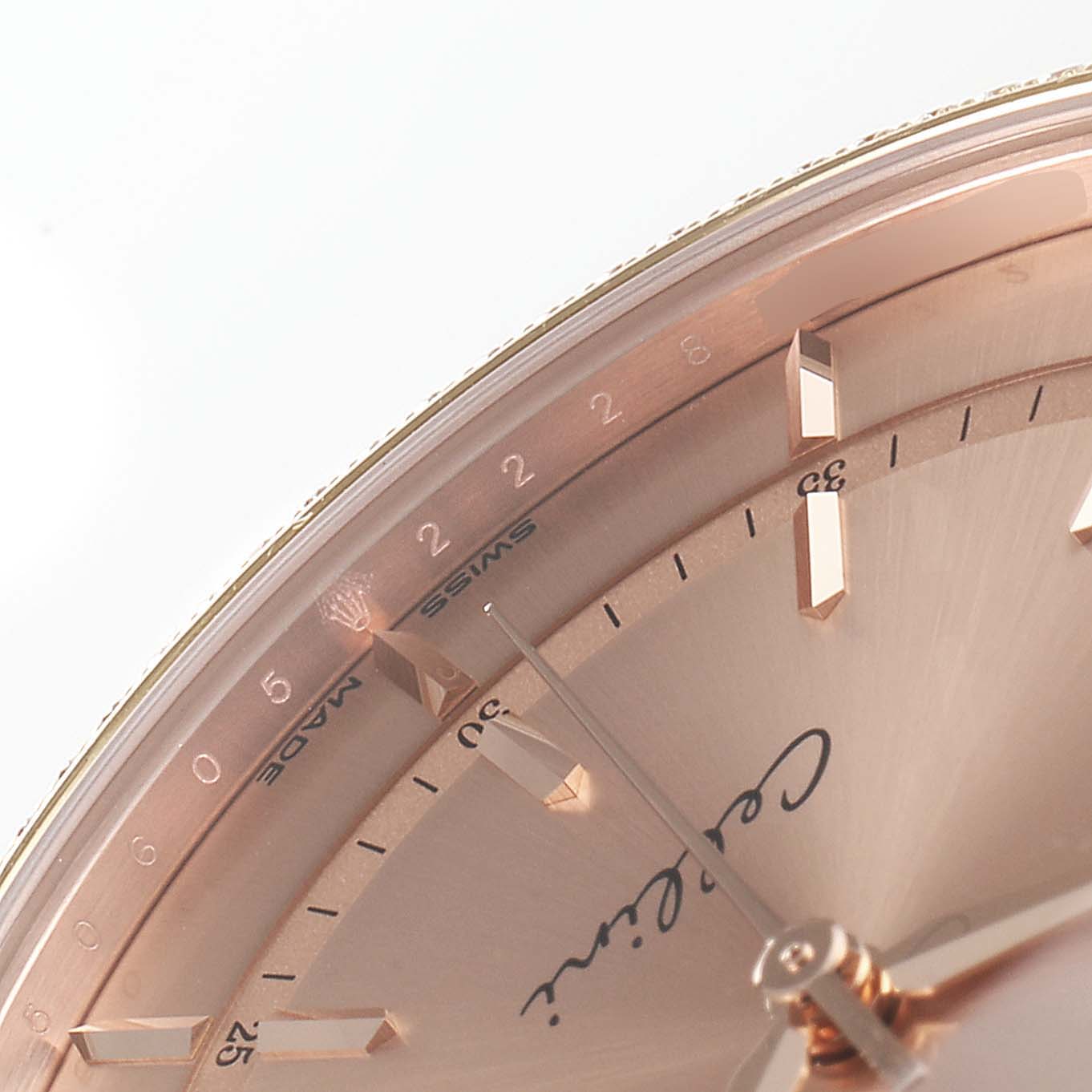 The image shows a close-up, partial view of the dial of a Rolex Cellini 50705 Men's Rose Gold Pink Dial 50705 Men's Rose Gold Pink Dial watch, focusing on the markers and branding near the "Swiss Made" text.