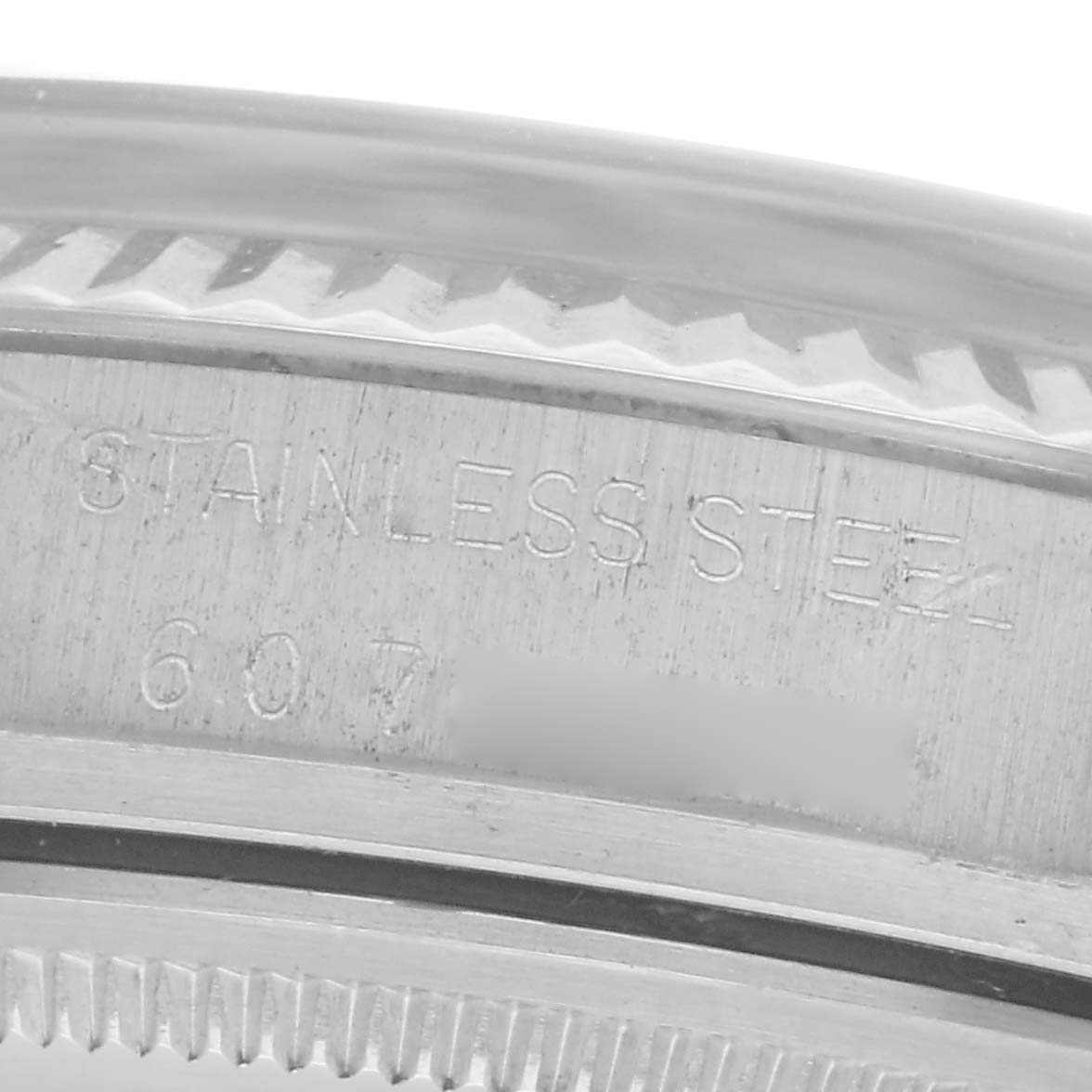 The image shows a close-up of the side case of a Rolex Datejust 16014 Men
s Stainless Steel Silver Dial 16014 Men
s Stainless Steel Silver Dial, highlighting the "STAINLESS STEEL" engraving.