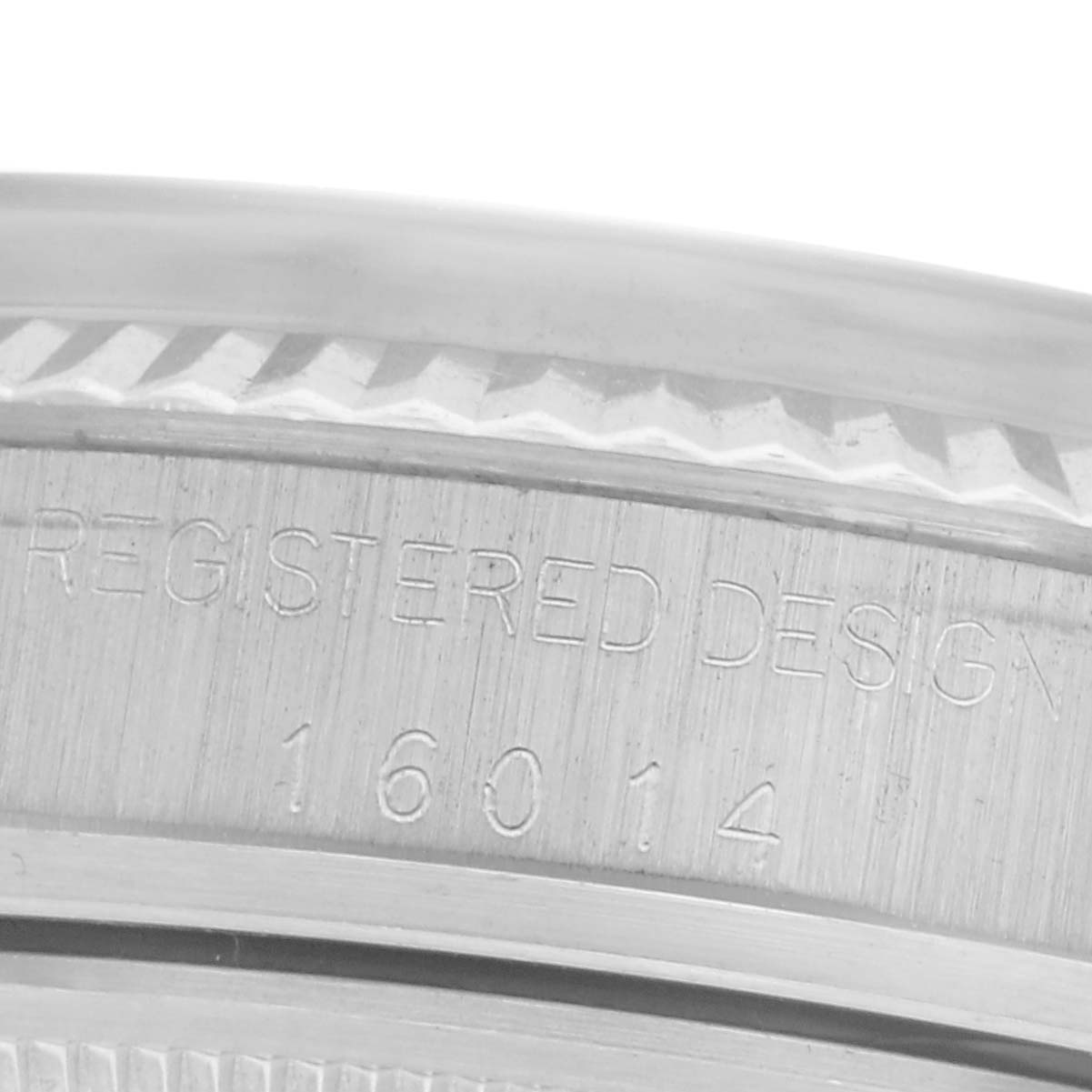This image shows a close-up of the side of the Rolex Datejust 16014 Men
s Stainless Steel Silver Dial 16014 Men
s Stainless Steel Silver Dial bezel with engraved text.