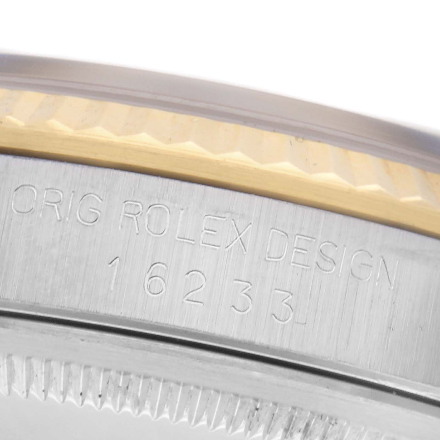 The image shows a close-up of the side of a Rolex Datejust 16233 Men
s Steel and Gold (two tone) Champagne Dial 16233 Men
s Steel and Gold (two tone) Champagne Dial, highlighting the bezel and engraved case design number.