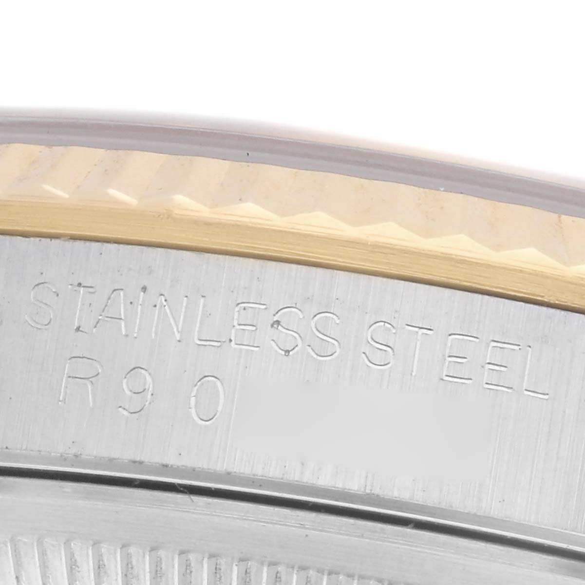 The image shows a close-up of the stainless steel case back and edge of the bezel of a Rolex Datejust 16233 Men
s Steel and Gold (two tone) Champagne Dial 16233 Men
s Steel and Gold (two tone) Champagne Dial watch.