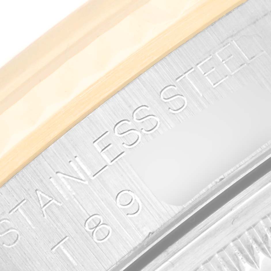 Close-up view of the edge and engraved text on the stainless steel case of a Rolex Datejust 16233 Men's Steel and Gold (two tone) Champagne Dial 16233 Men's Steel and Gold (two tone) Champagne Dial watch.