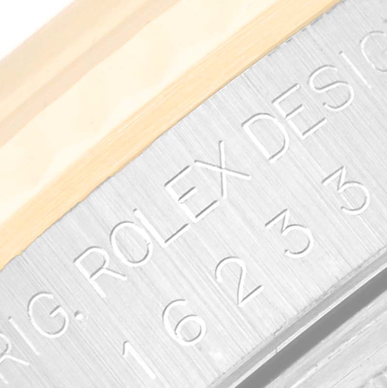 This close-up image shows the engraved side of the case on a Rolex Datejust 16233 Men's Steel and Gold (two tone) Champagne Dial 16233 Men's Steel and Gold (two tone) Champagne Dial watch.