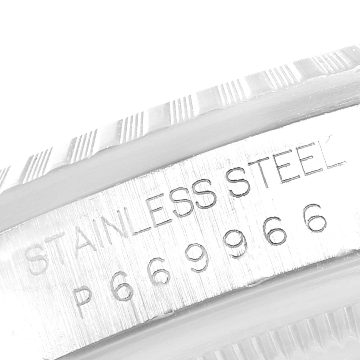 This is a close-up of the bezel and case side of the Rolex Datejust 16220 Men's Stainless Steel White Dial 16220 Men's Stainless Steel White Dial, showing stainless steel material and serial number.