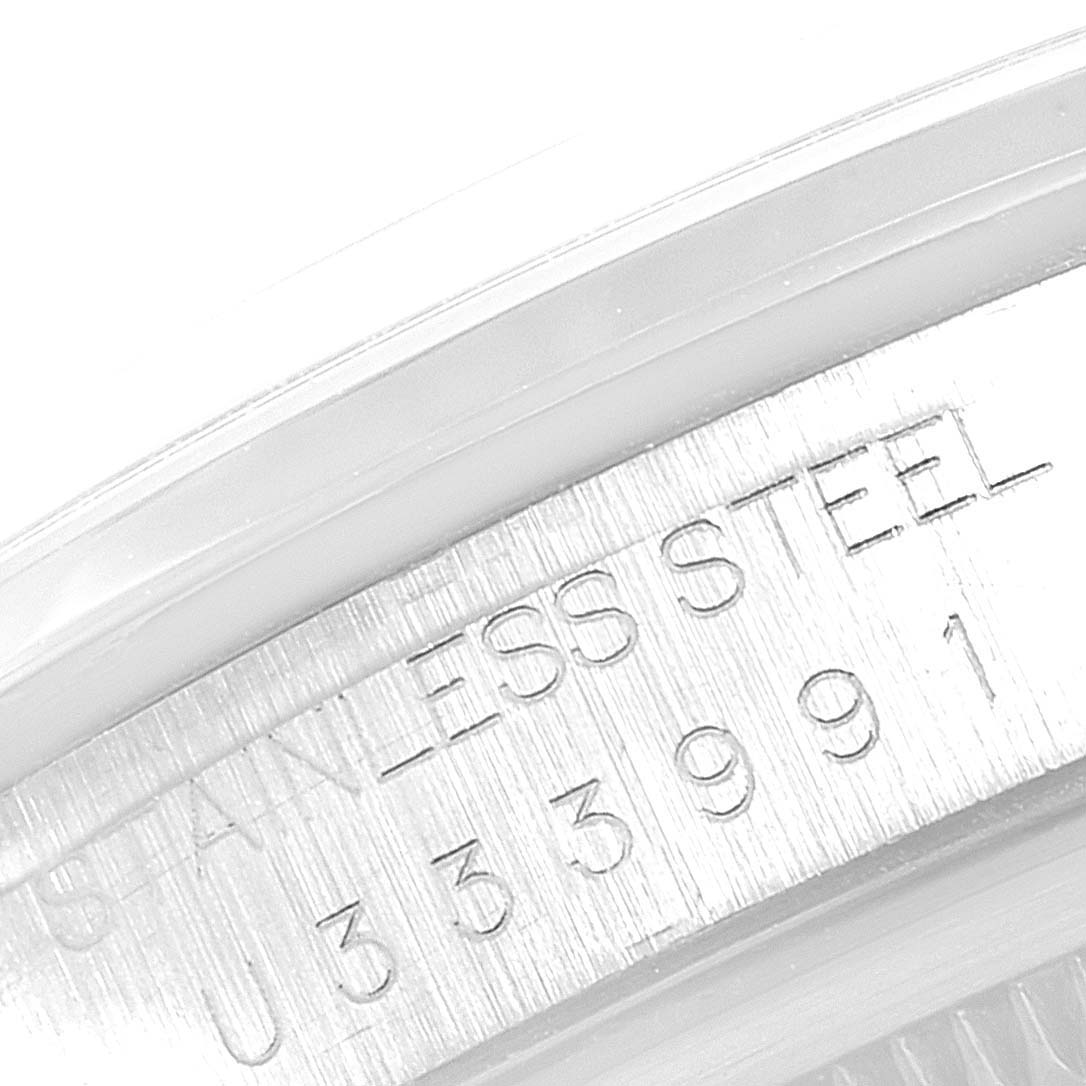 This image shows a close-up of the stainless steel casing with engravings on a Rolex Datejust 16200 Men's Stainless Steel Blue Dial 16200 Men's Stainless Steel Blue Dial watch.