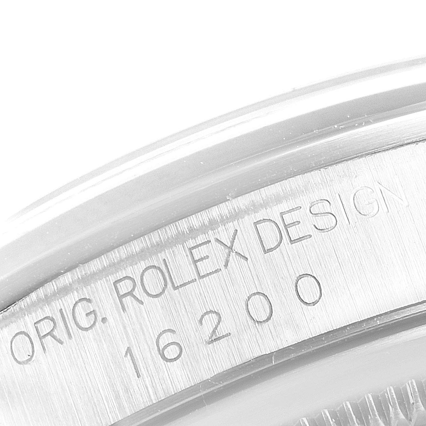This is a close-up of the watch case of a Rolex Datejust 16200 Men's Stainless Steel Blue Dial 16200 Men's Stainless Steel Blue Dial model, showing the engraved text and model number "16200".