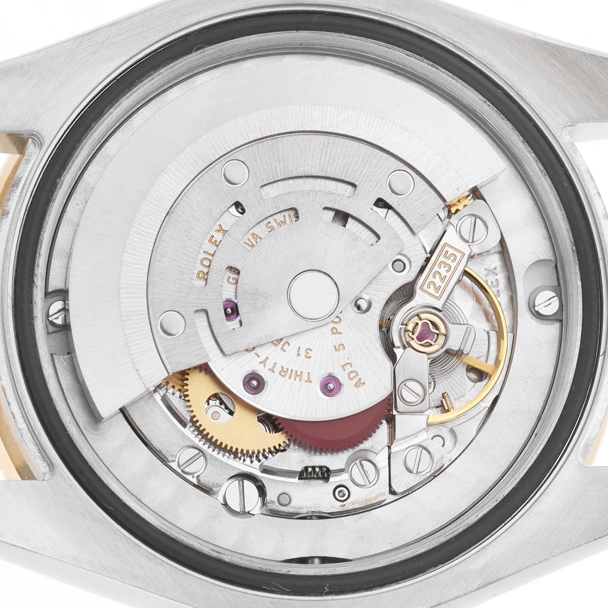 The image shows the inner mechanism of a Rolex Datejust Midsize 31 model, highlighting its intricate parts and gears.