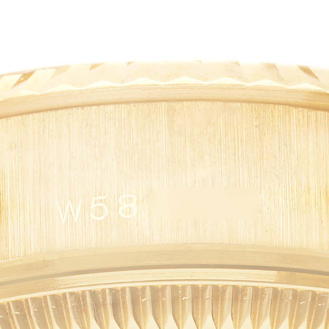 The image shows a close-up of the case side and bezel edge of a Rolex President 69178 Women
s Yellow Gold Champagne Dial 69178 Women
s Yellow Gold Champagne Dial model, highlighting the serial number.