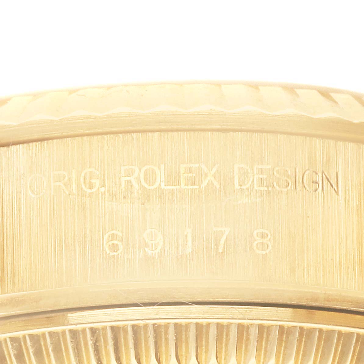 This close-up image shows the engraving on the side of the bezel and case of a Rolex President 69178 Women
s Yellow Gold Champagne Dial 69178 Women
s Yellow Gold Champagne Dial model watch.