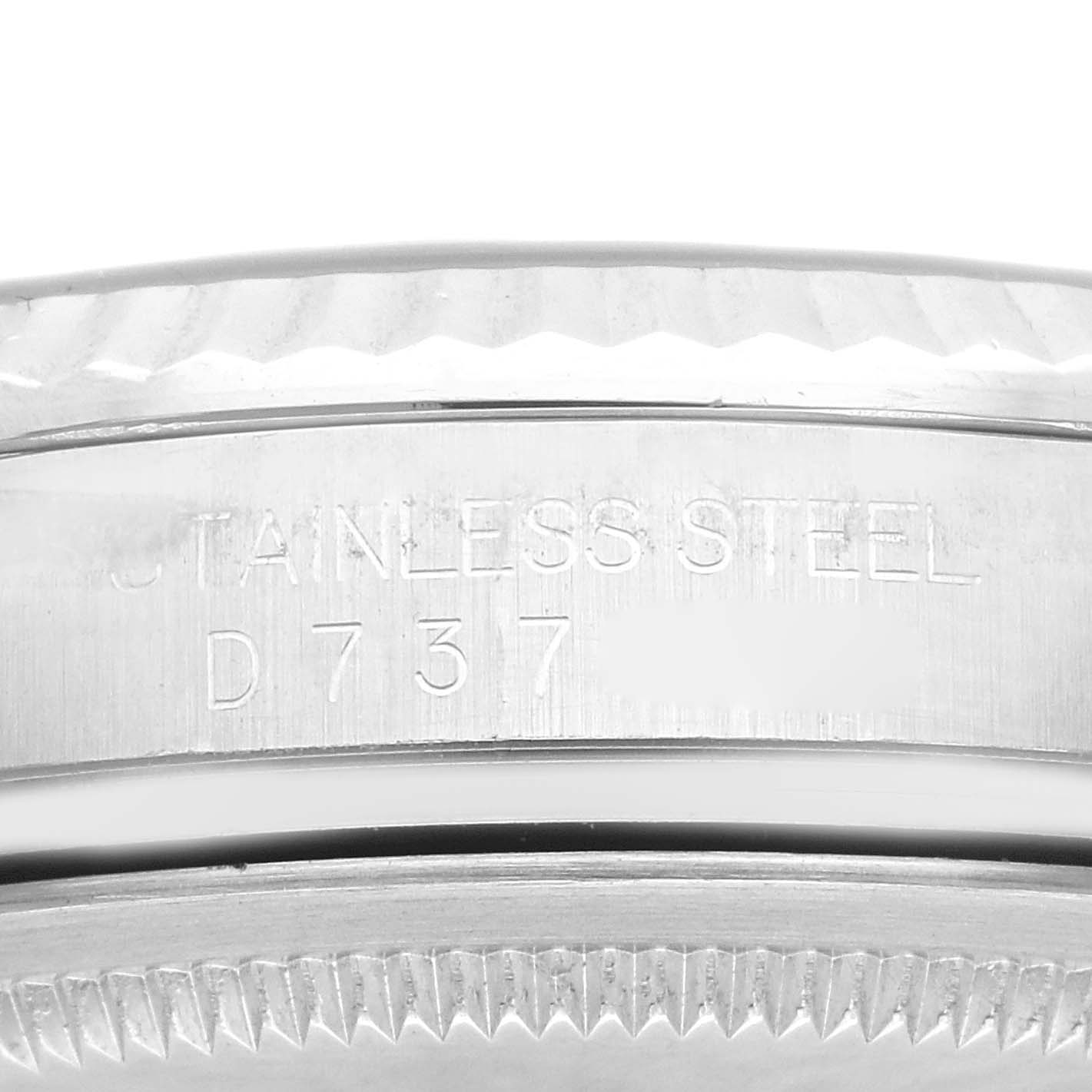 The image shows an extreme close-up of the case side and bezel of a Rolex Datejust 116234 Men's Stainless Steel Black Dial 116234 Men's Stainless Steel Black Dial watch, highlighting the engraved "STAINLESS STEEL" text.